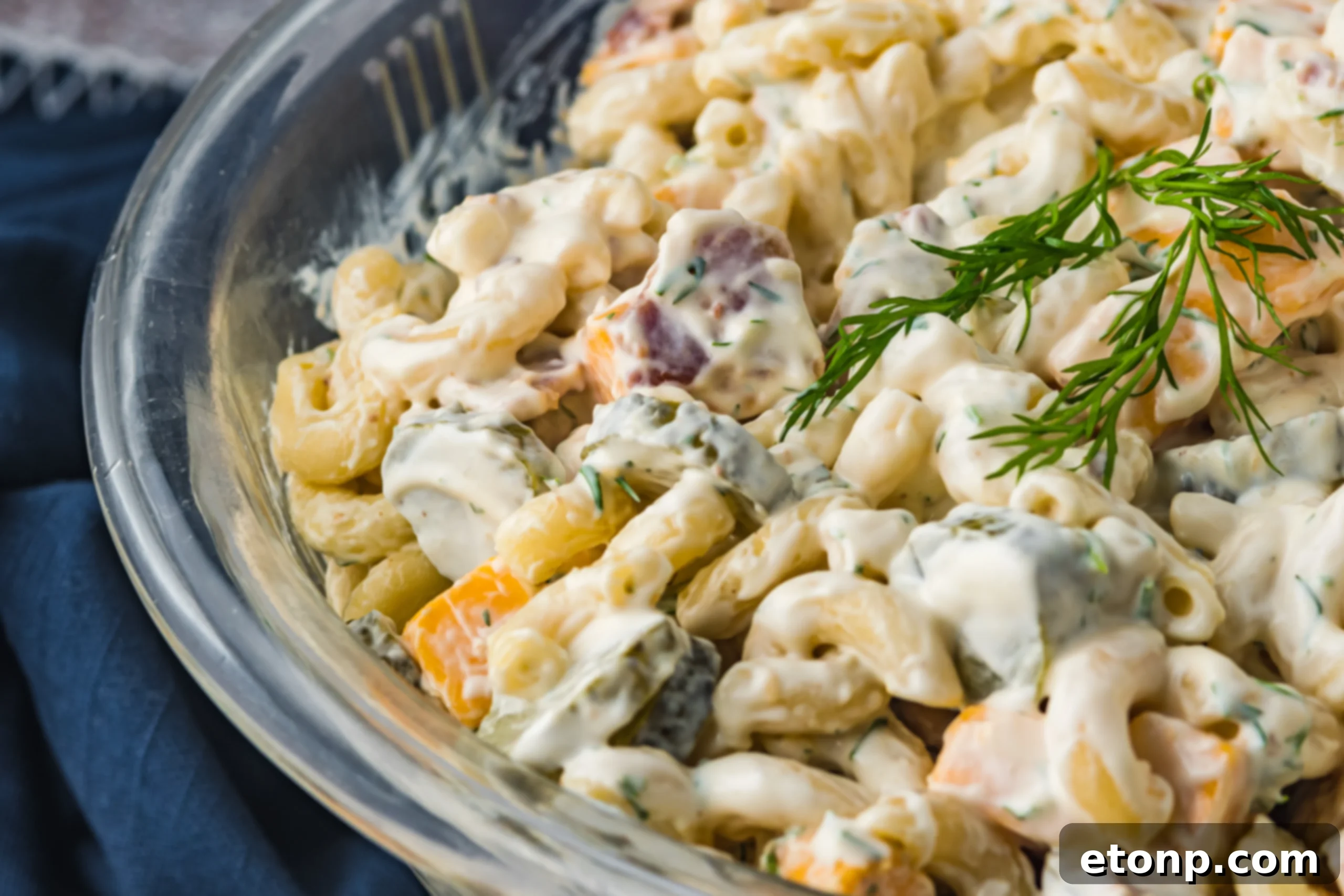 A large platter of Dill Pickle Pasta Salad, showcasing its vibrant colors and ingredients.