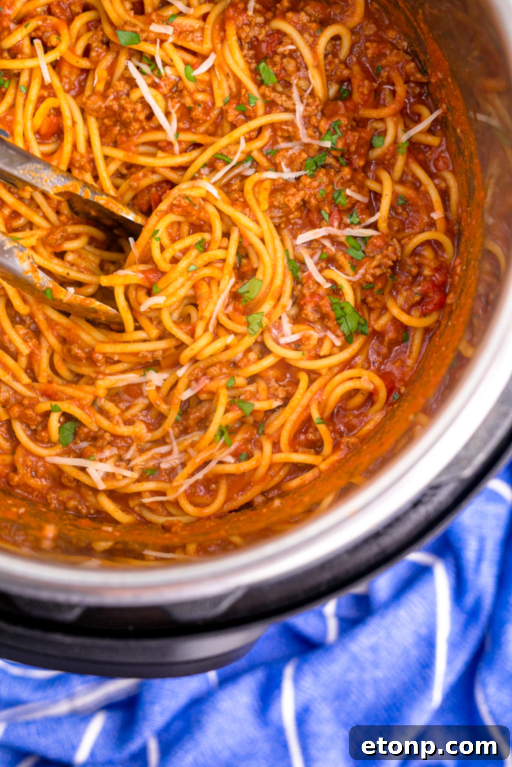 One-Pot Instant Pot Spaghetti 11 Overhead shot of Instant Pot Spaghetti being mixed with tongs in the Instant Pot