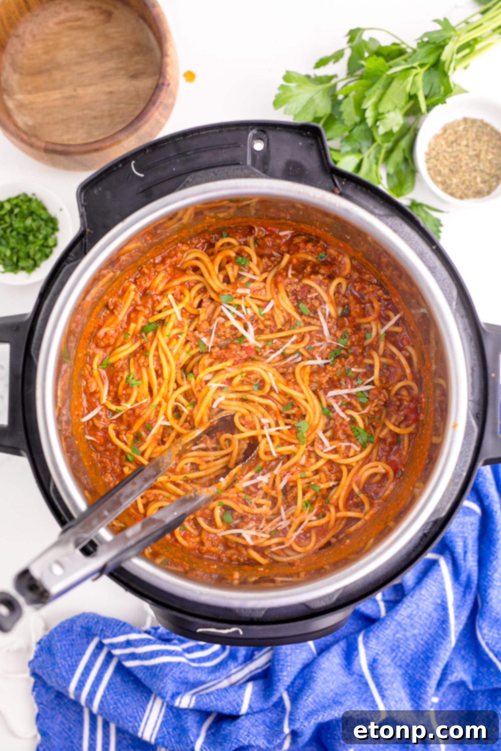 One-Pot Instant Pot Spaghetti 15 Overhead shot of Instant Pot Spaghetti being mixed with tongs in the Instant Pot