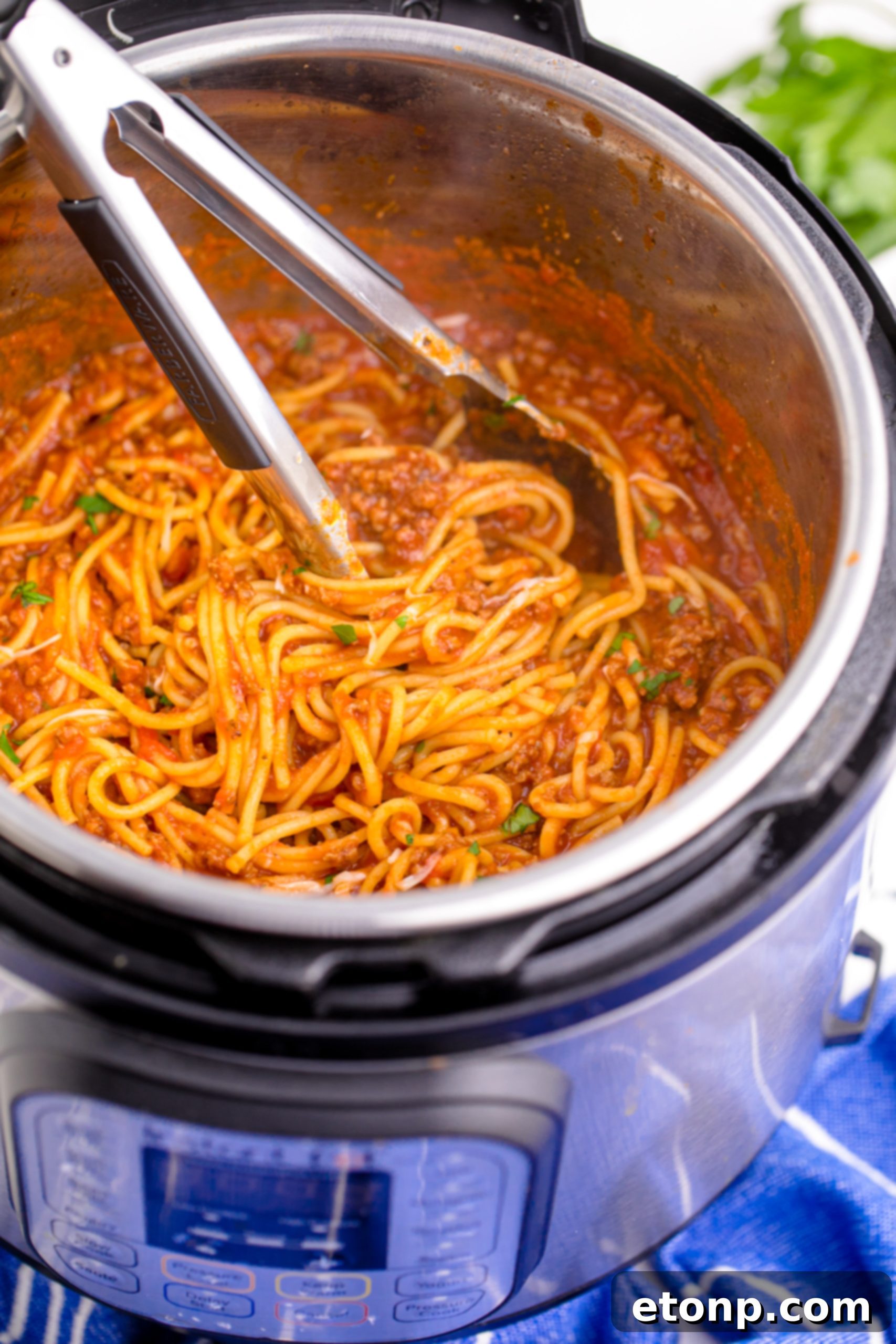 One-Pot Instant Pot Spaghetti 10 Instant Pot Spaghetti being mixed with tongs in the Instant Pot