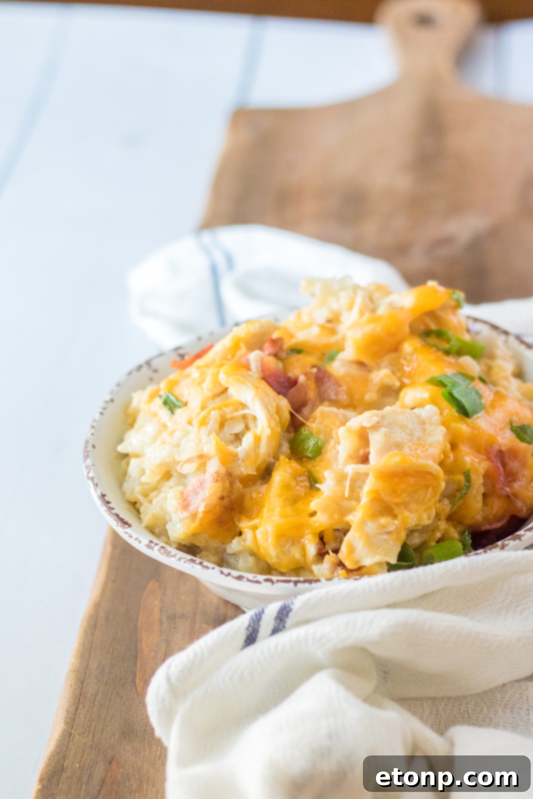 Tater Tot Casserole in a white bowl from the side