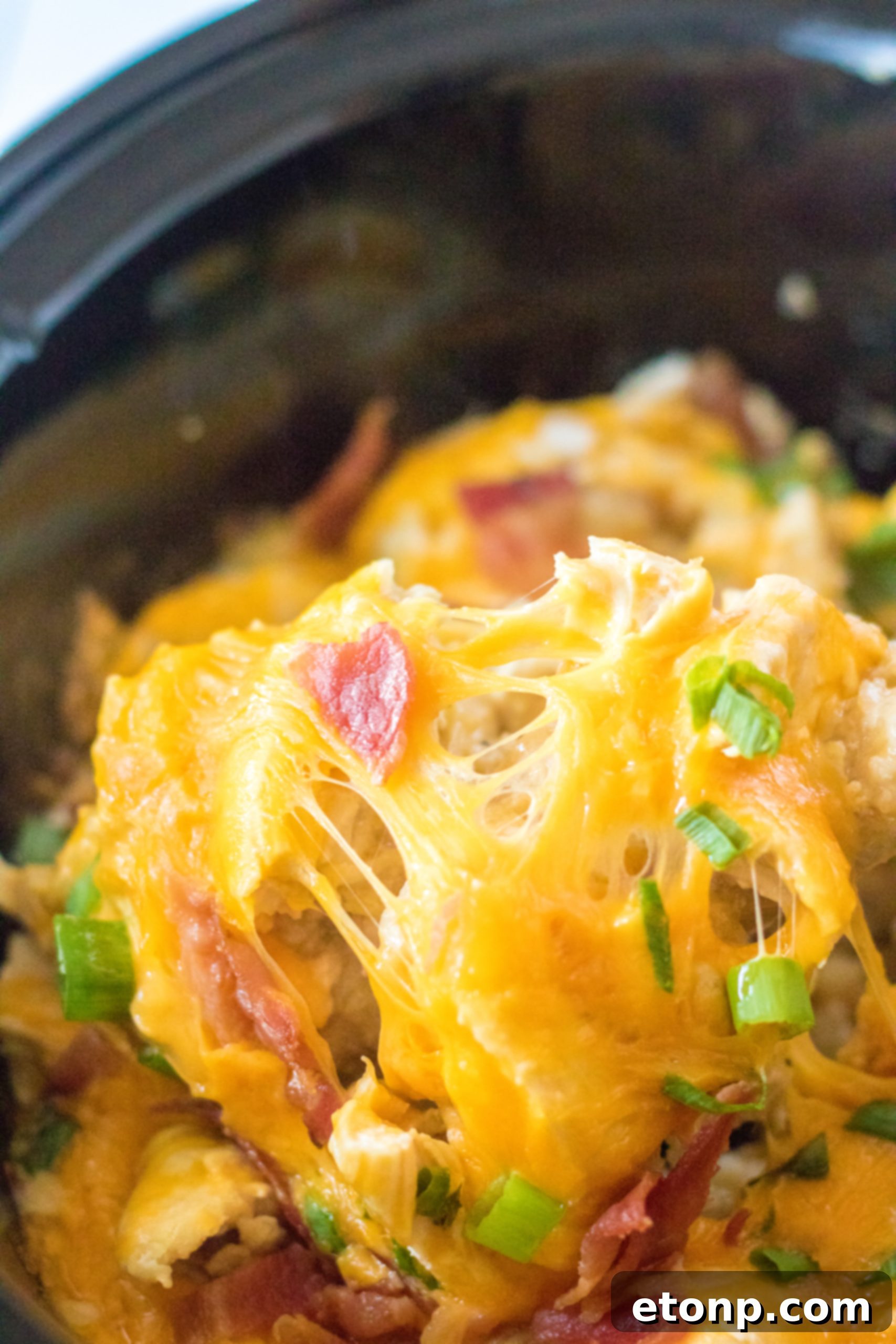 Tater Tot Casserole in the crock pot on a spoon