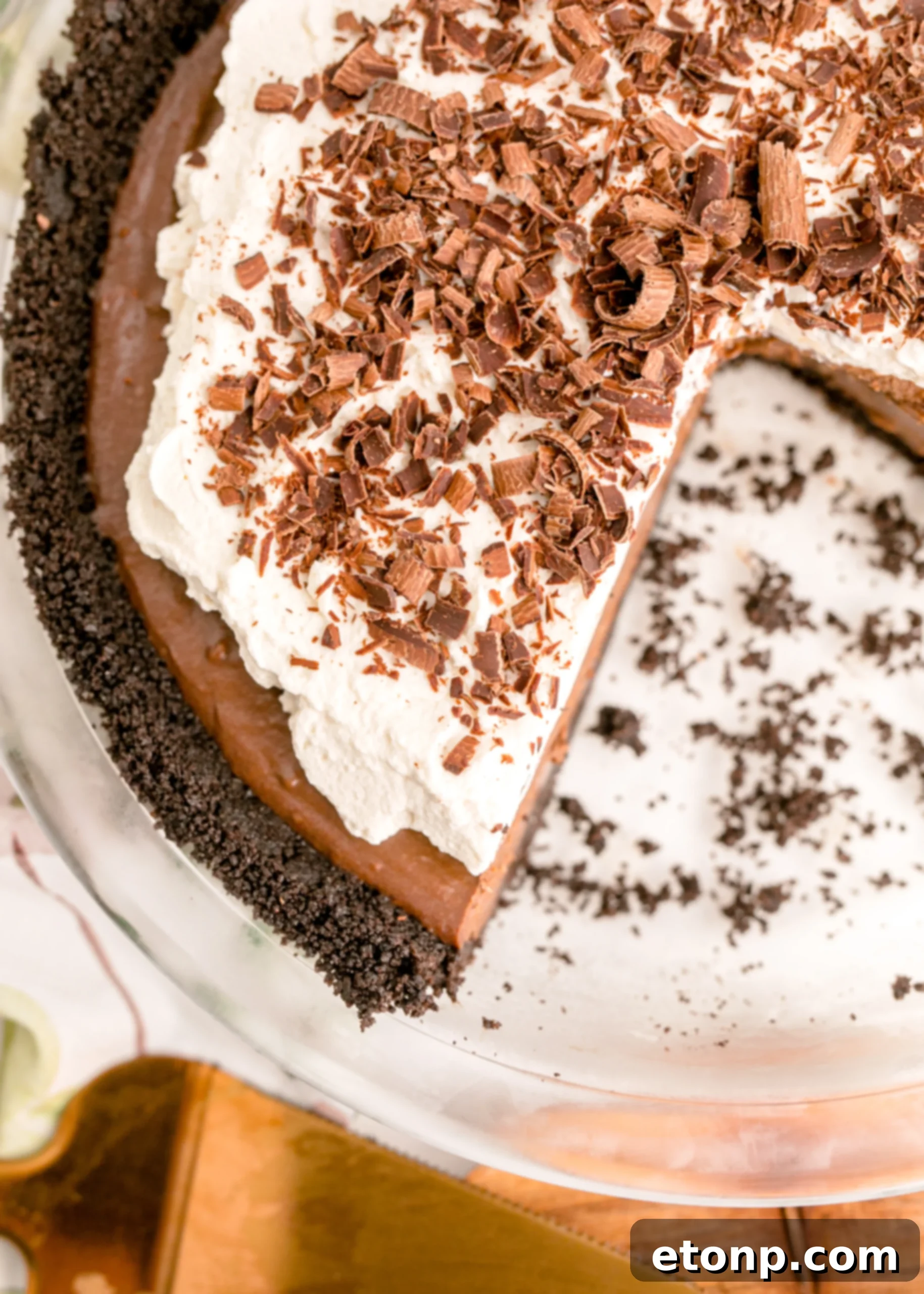 Chocolate Cream Pie topped with whipped cream and chocolate shavings in a white pie dish, overhead shot for a perfect view