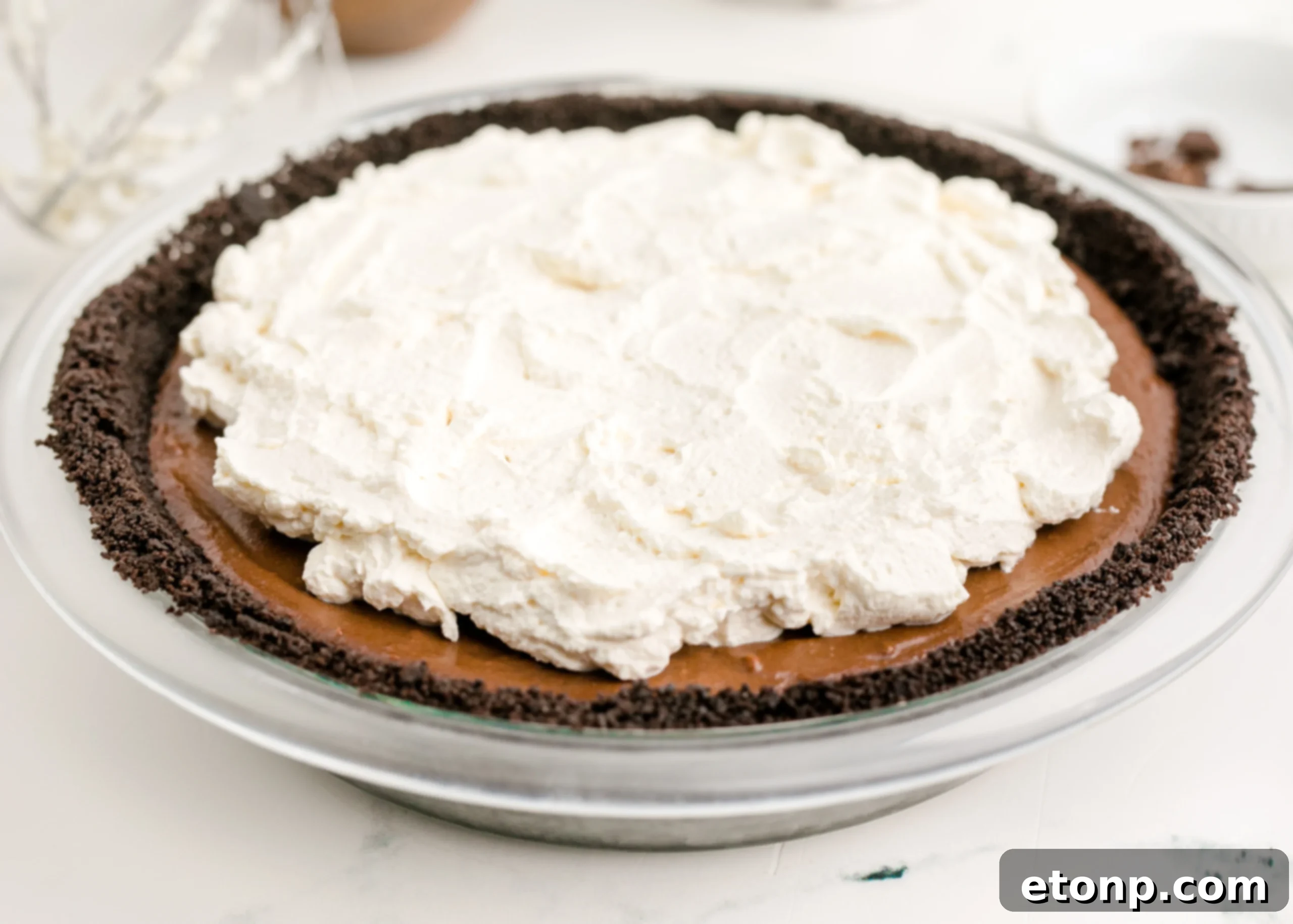 Chocolate Cream Pie topped generously with real whipped cream and chocolate shavings