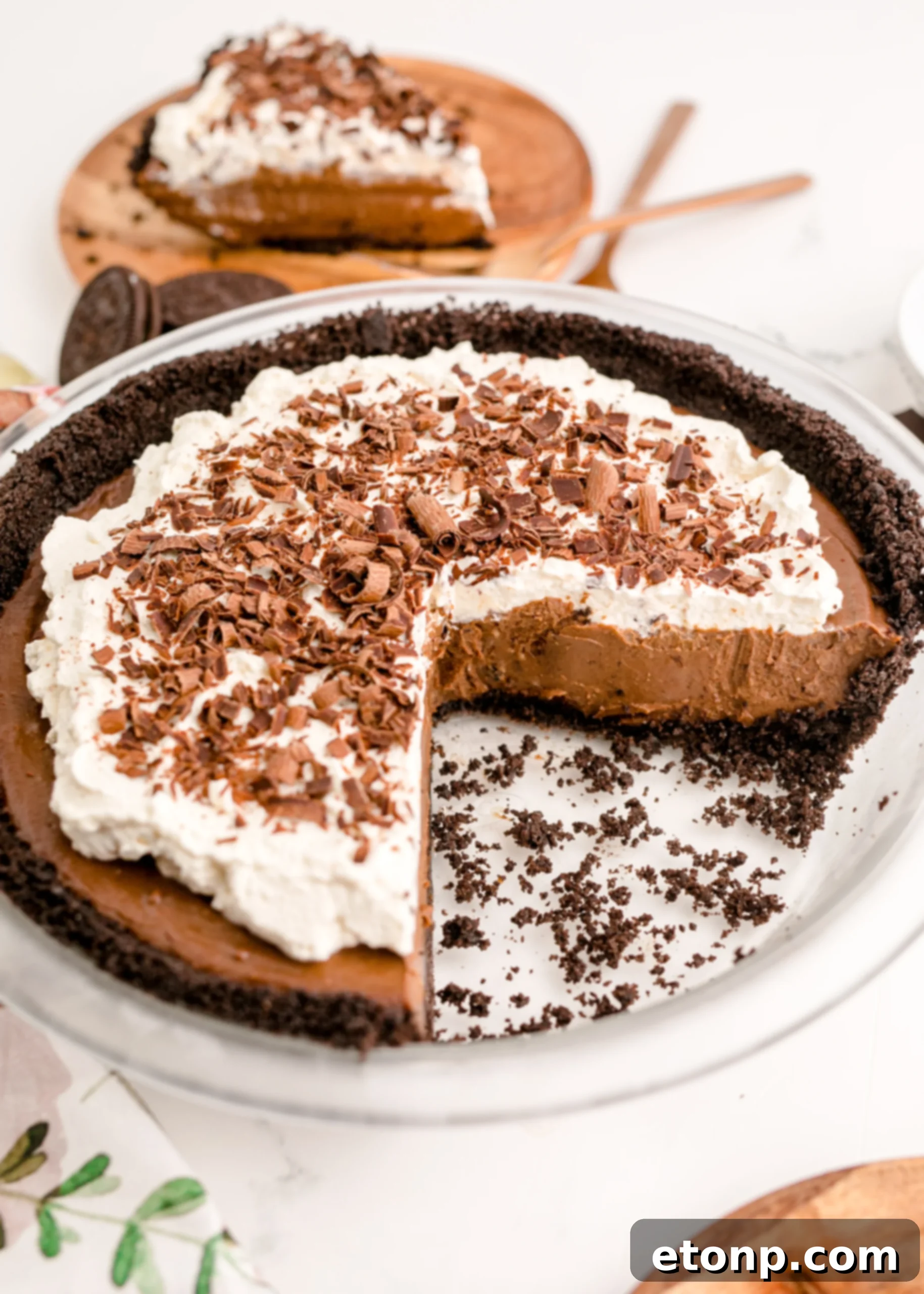 Chocolate Cream Pie topped with whipped cream and chocolate shavings in a full pie dish