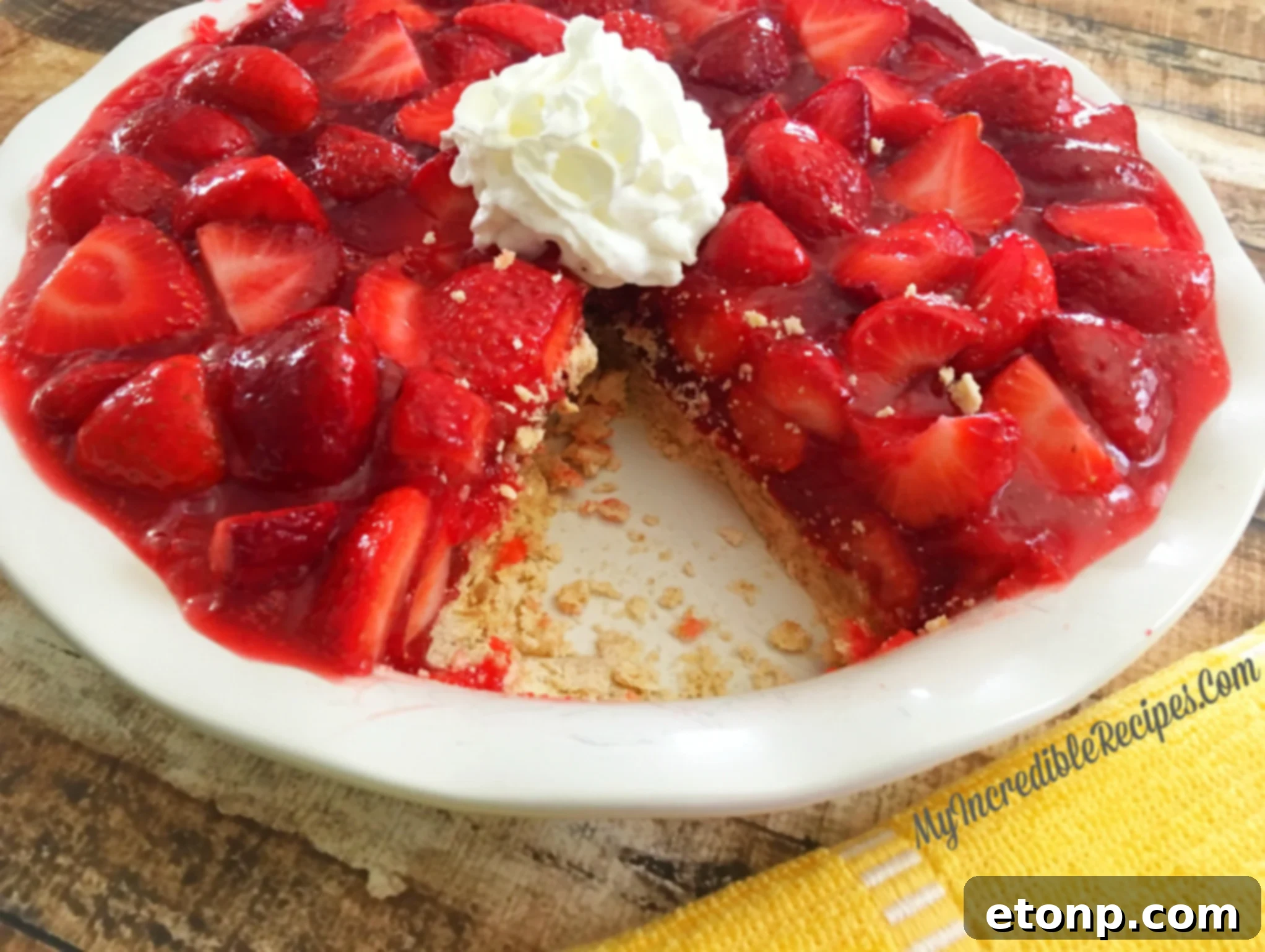 The Ultimate Strawberry Pie 19 A bowl of whipped cream next to a strawberry pie slice
