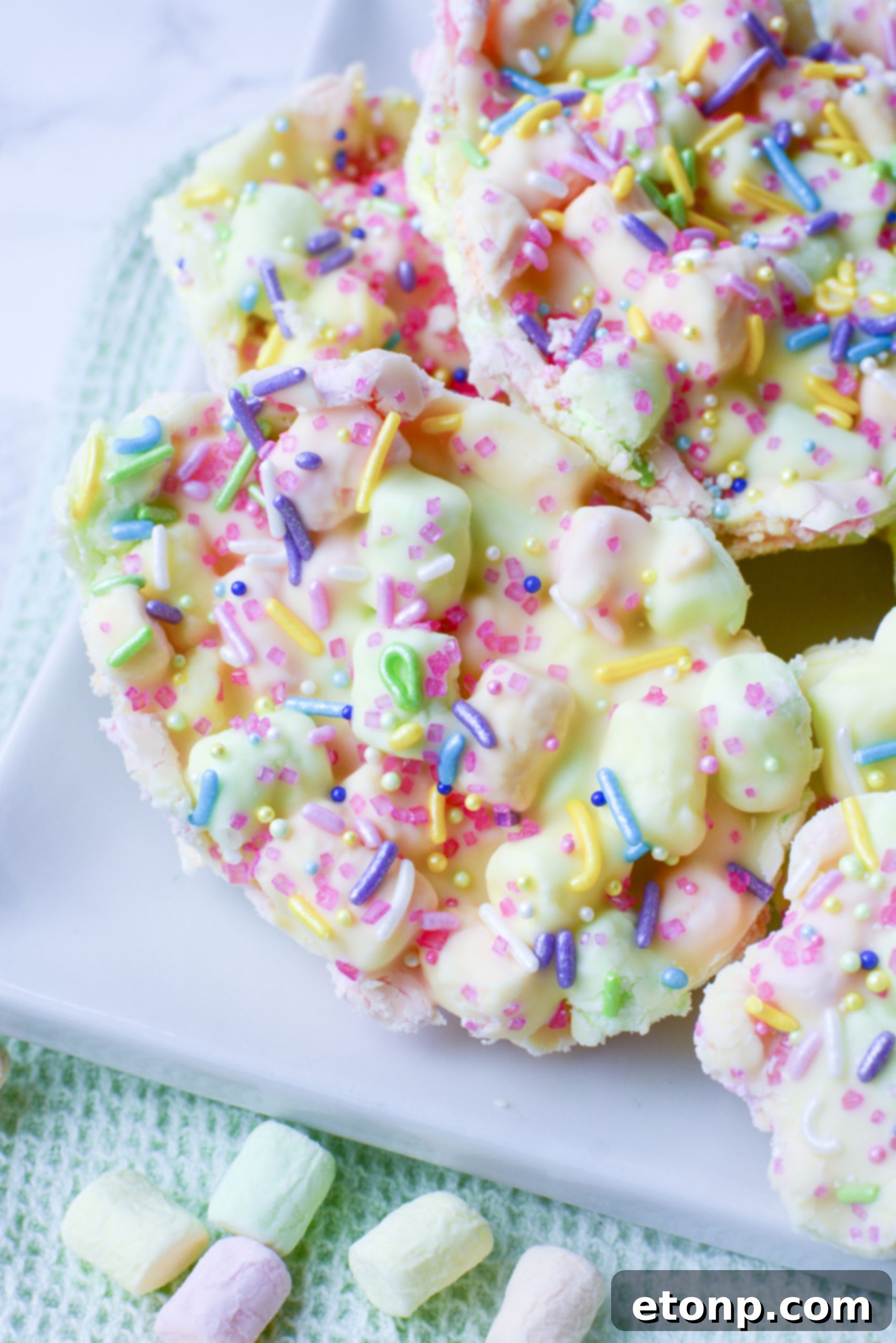 Easter Marshmallow treats with pink, green and yellow mini marshmallows cut into the shape of eggs