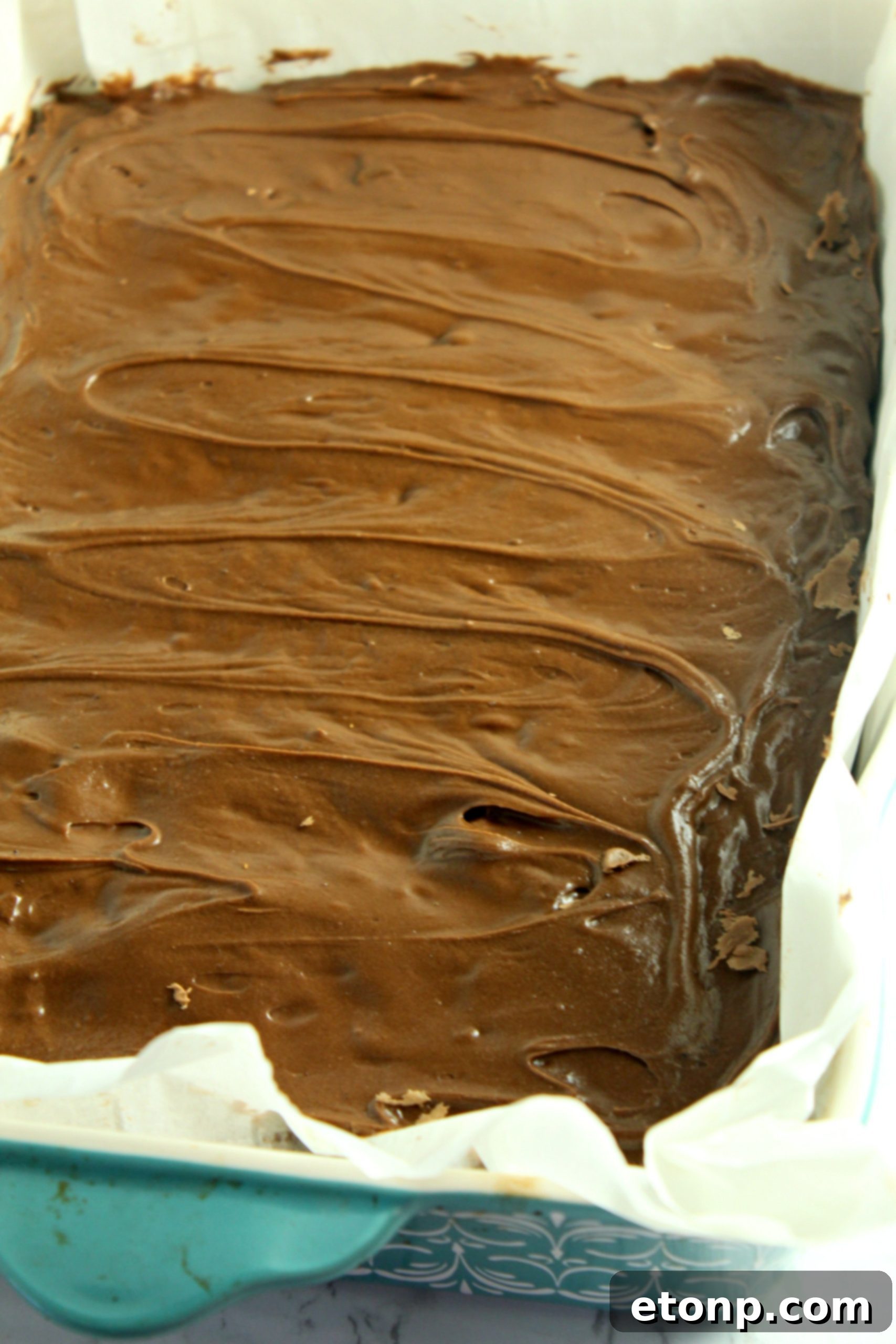 Homemade chocolate frosted lunch lady Brownies in a baking dish uncut