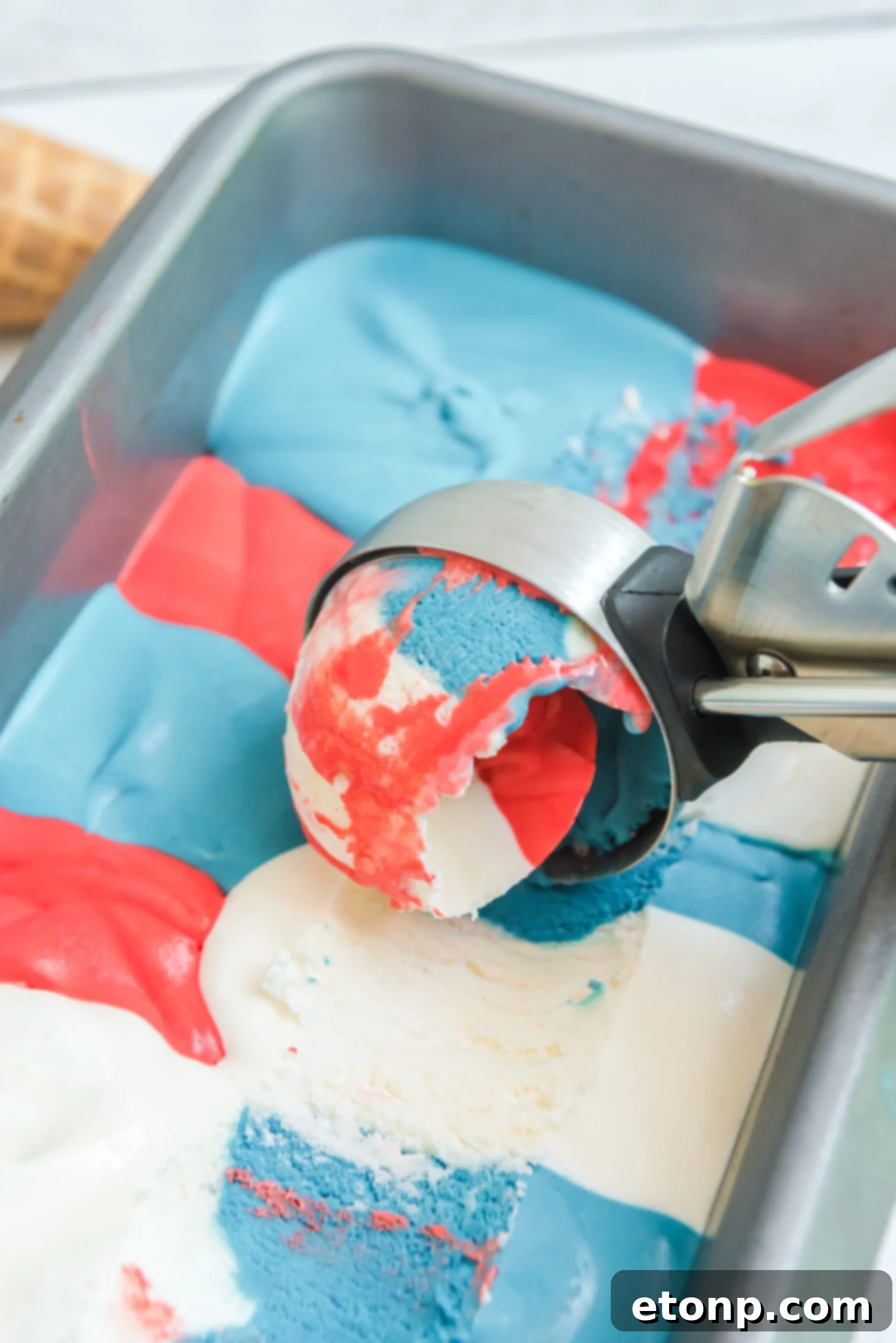 Red, White & Blue Ice Cream in an aluminum loaf pan with an ice cream scoop