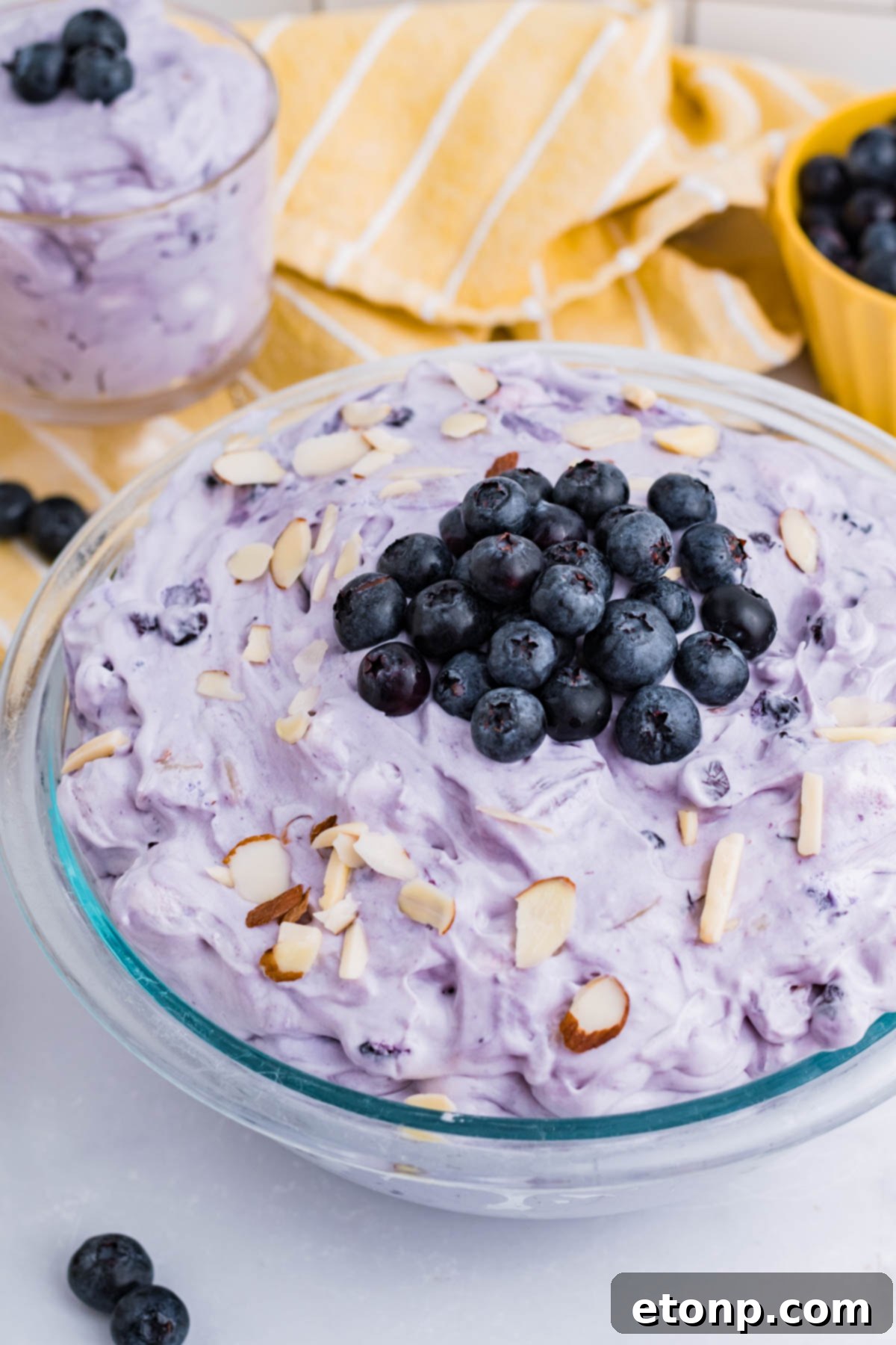 Blueberry Fluff Salad in a clear glass serving bowl overhead shot