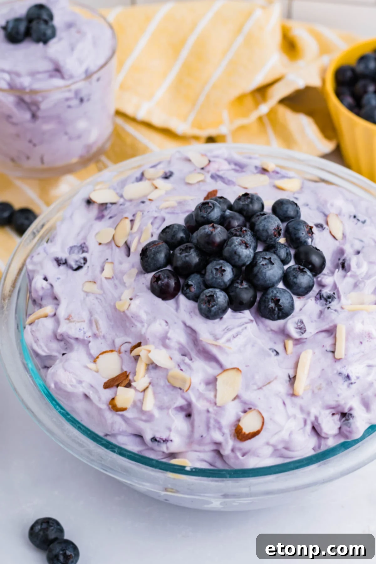 Blueberry Fluff Salad in a clear glass serving bowl overhead shot