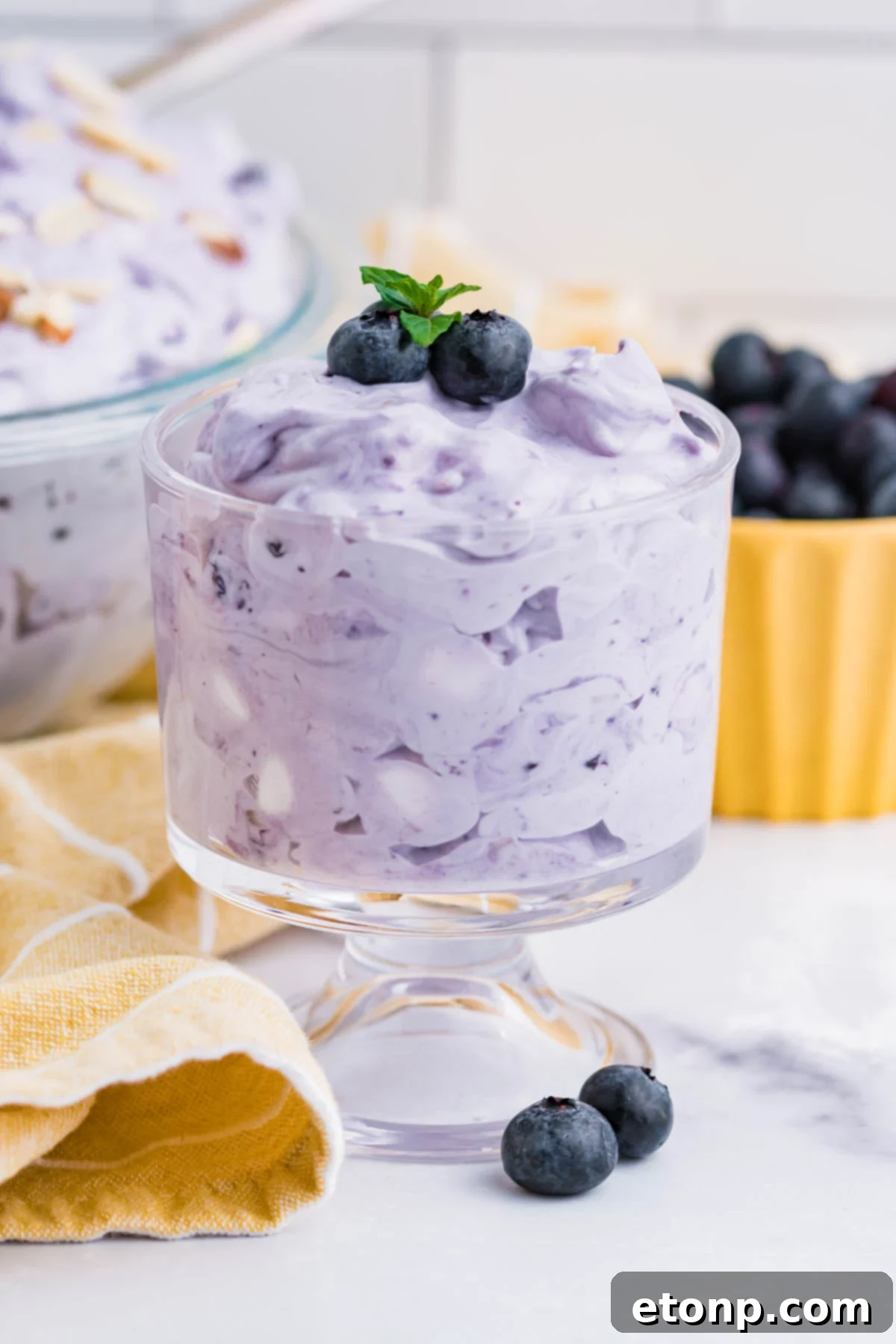 Blueberry Fluff Salad in a clear glass mini trifle side angle