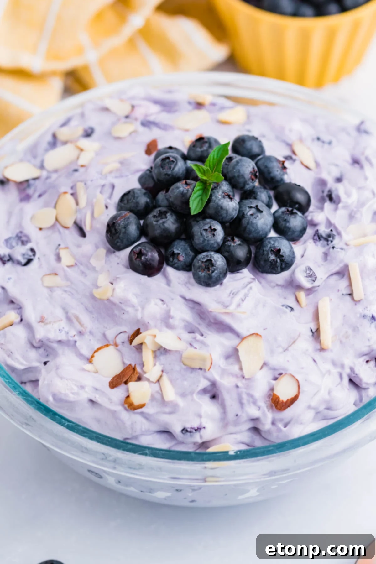 Blueberry Fluff Salad in a clear glass serving bowl overhead shot