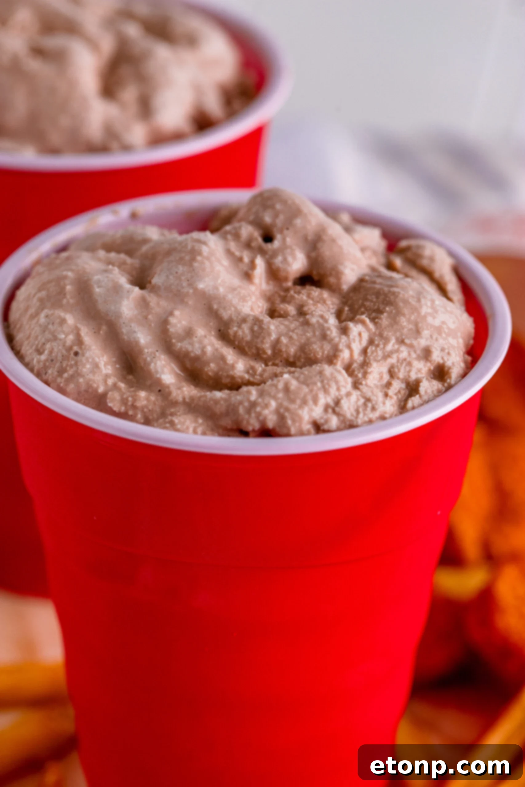 Side view close-up of a homemade Wendy's Frosty in a red solo cup, showing its appealing texture and readiness to be served.