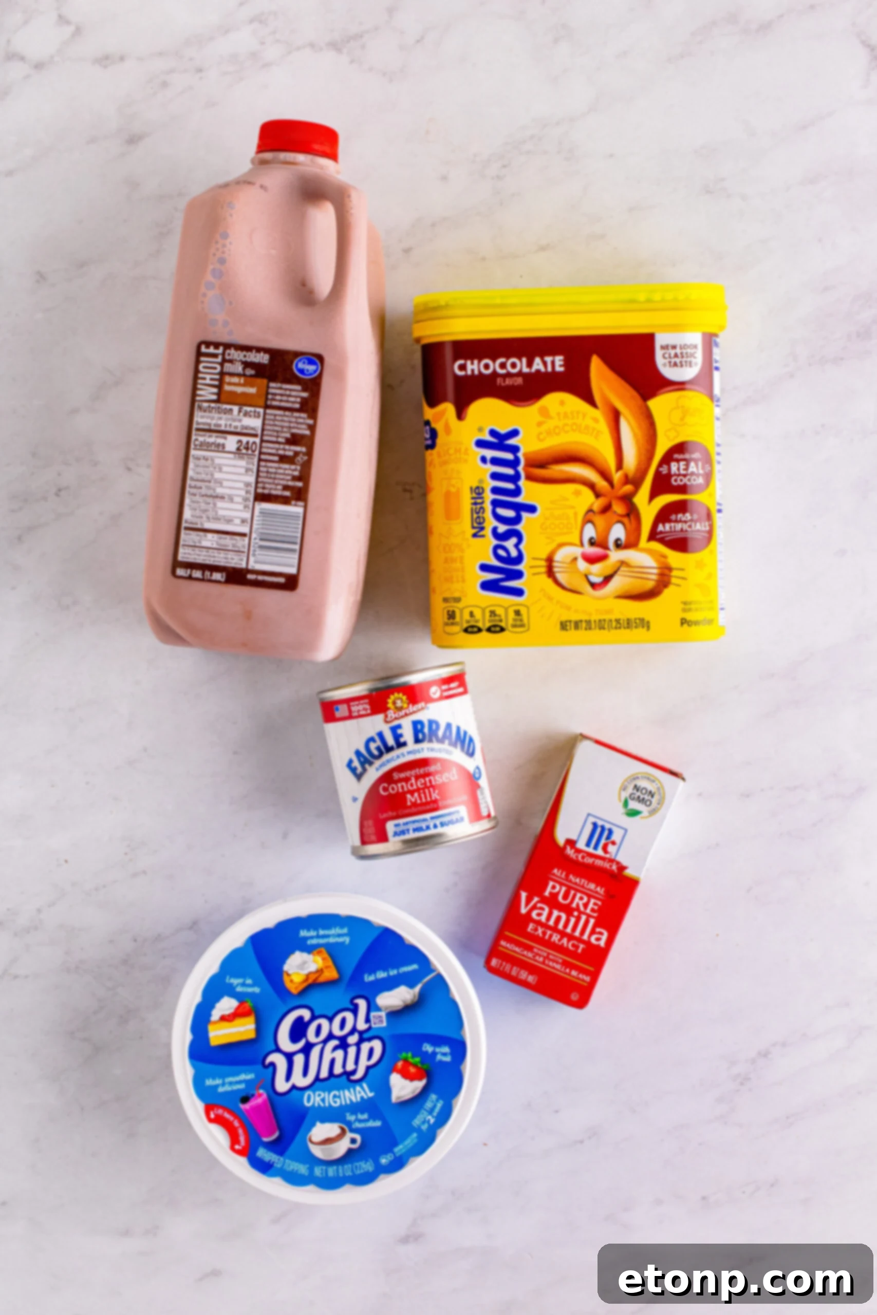The five simple ingredients for a homemade Wendy's Frosty: chocolate milk, Nesquik powder, sweetened condensed milk, whipped topping, and vanilla extract.