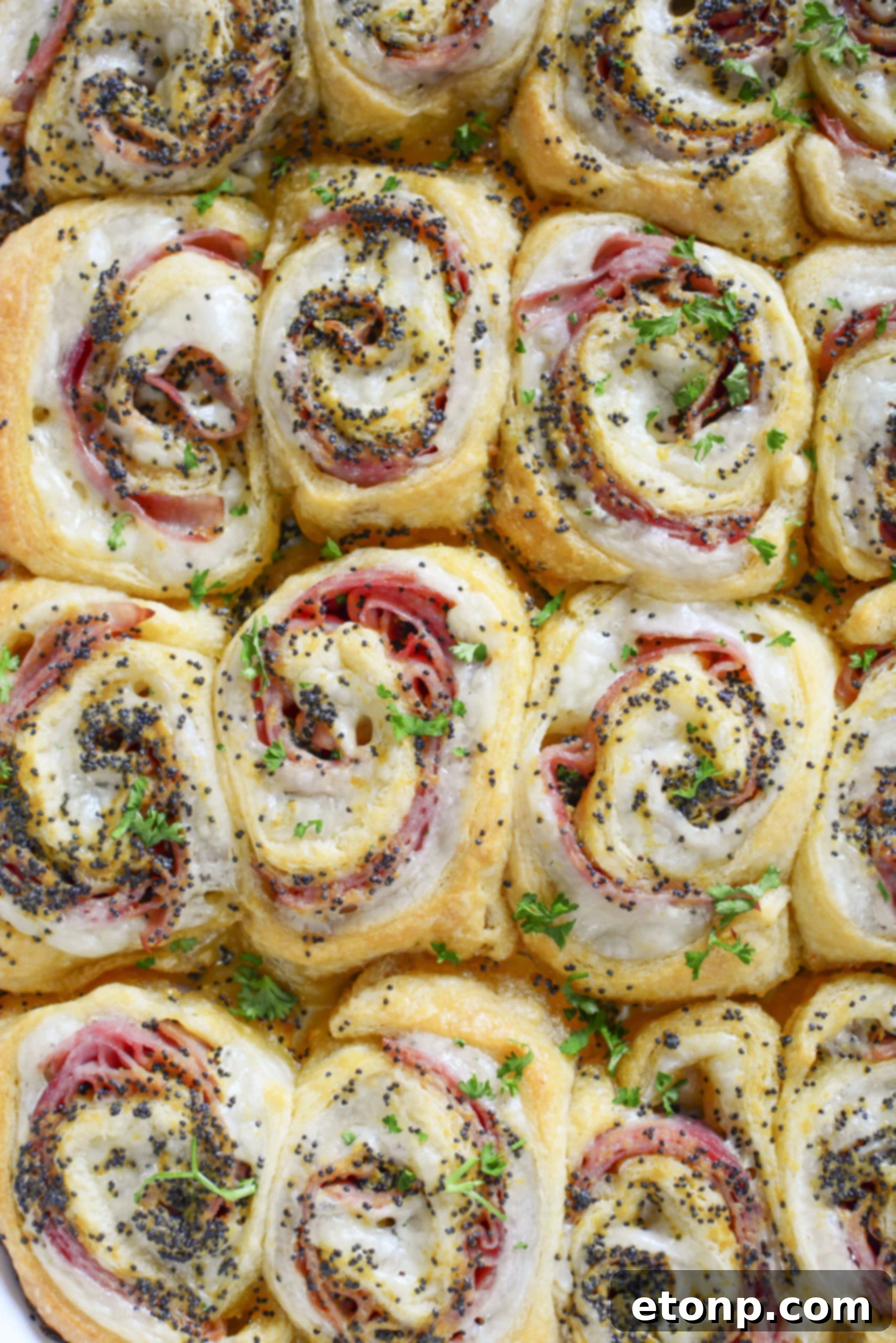 Ham and Cheese Pinwheels in a white baking dish overhead photo