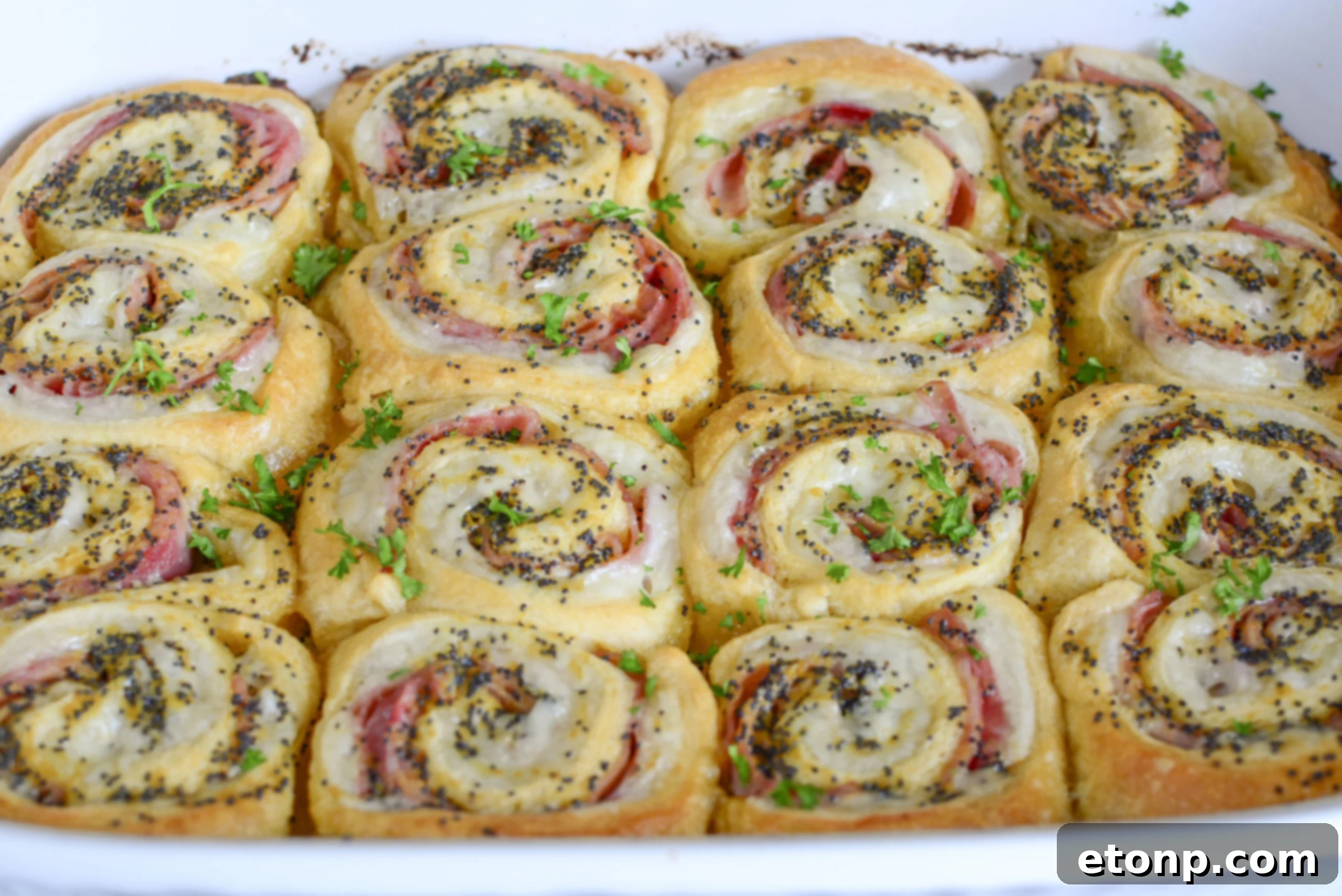 Ham and Cheese Pinwheels in a white baking dish