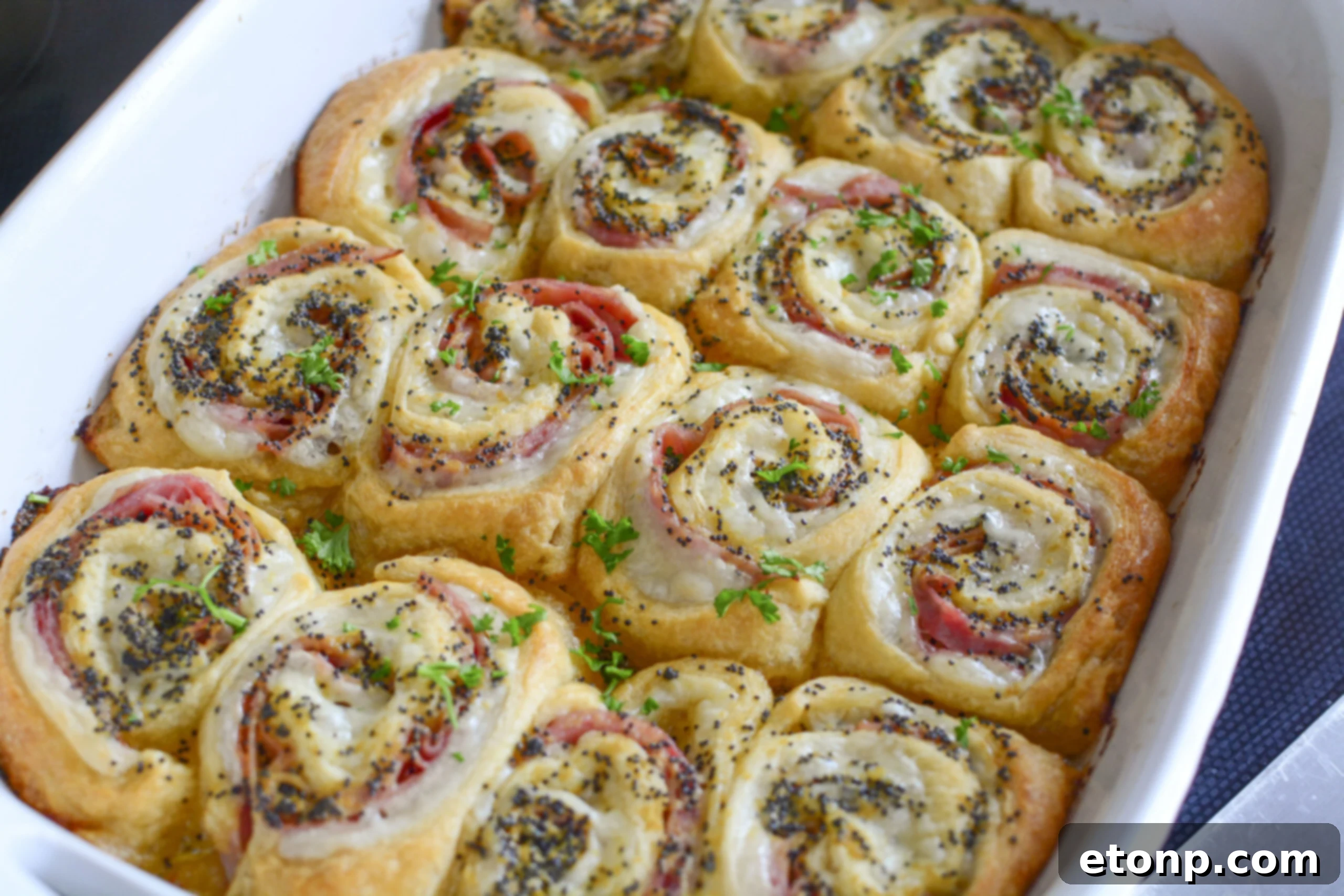 Ham and Cheese Pinwheels in a white baking dish