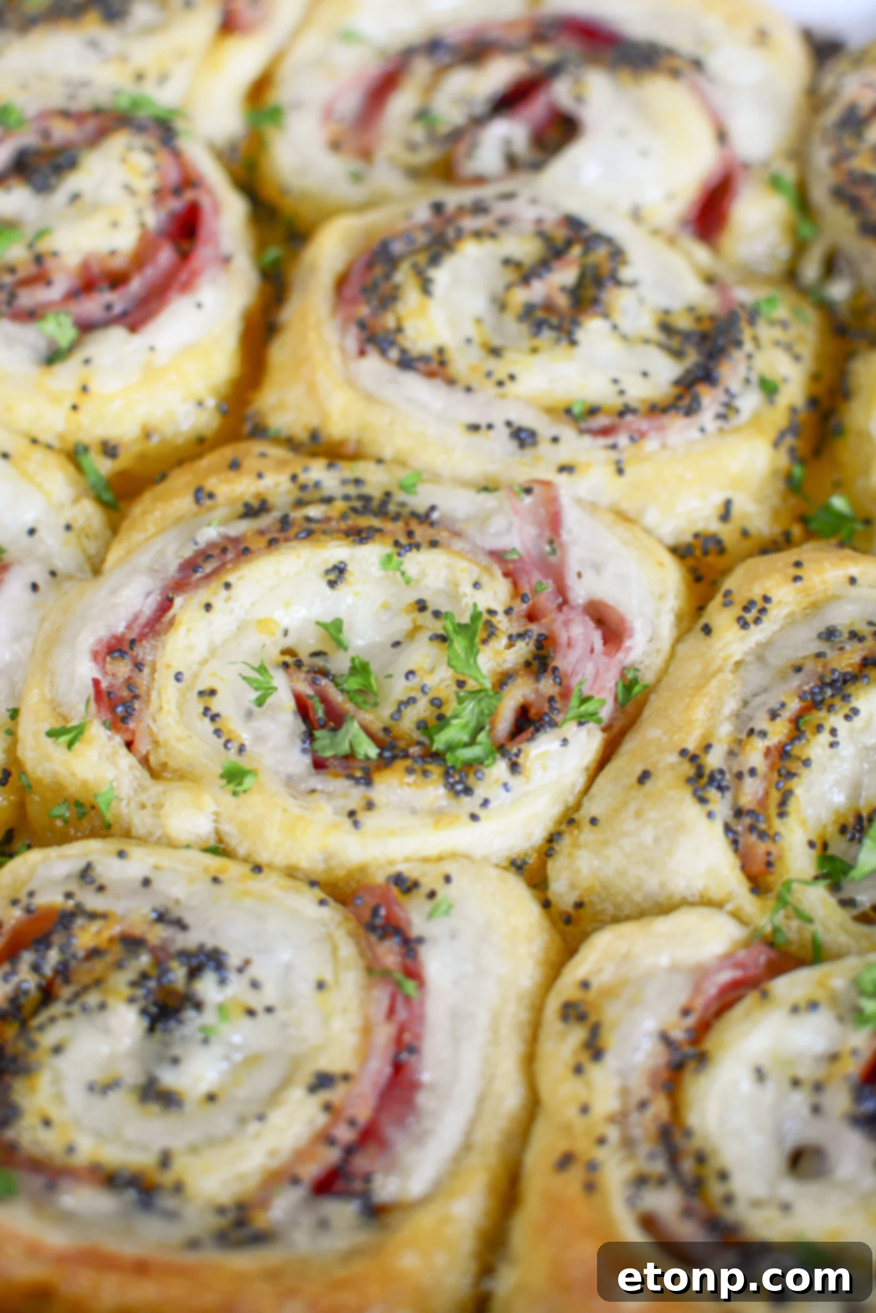Ham and Cheese Pinwheels in a white baking dish overhead angle