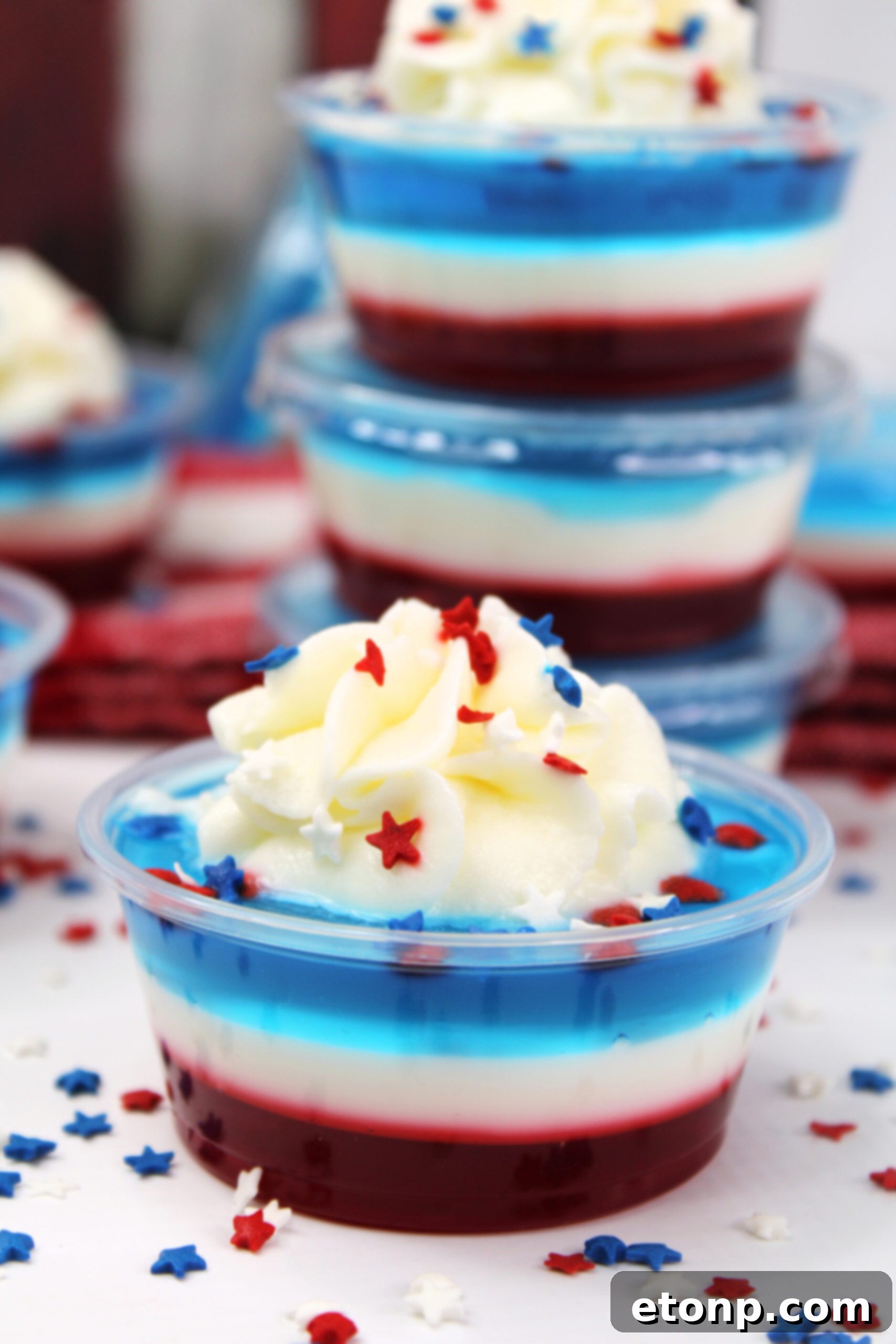 Bomb Pop Jello Shot layered red, white & blue topped with whipped cream