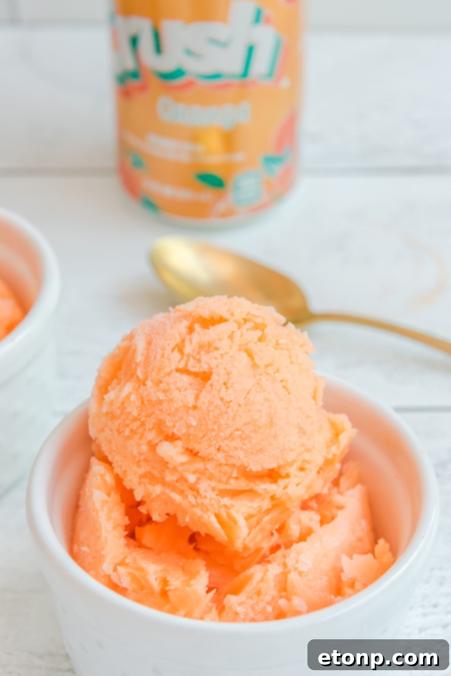 Sunburst Orange Sherbet 2 Refreshing Orange Crush Sherbet served in a white bowl, ready to be enjoyed