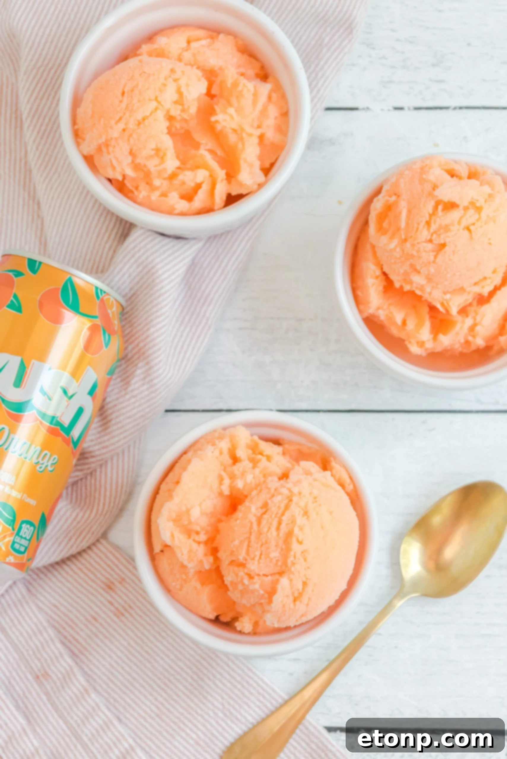 Sunburst Orange Sherbet 12 Three bowls of vibrant Orange Crush Sherbet, accompanied by a can of Orange Crush soda