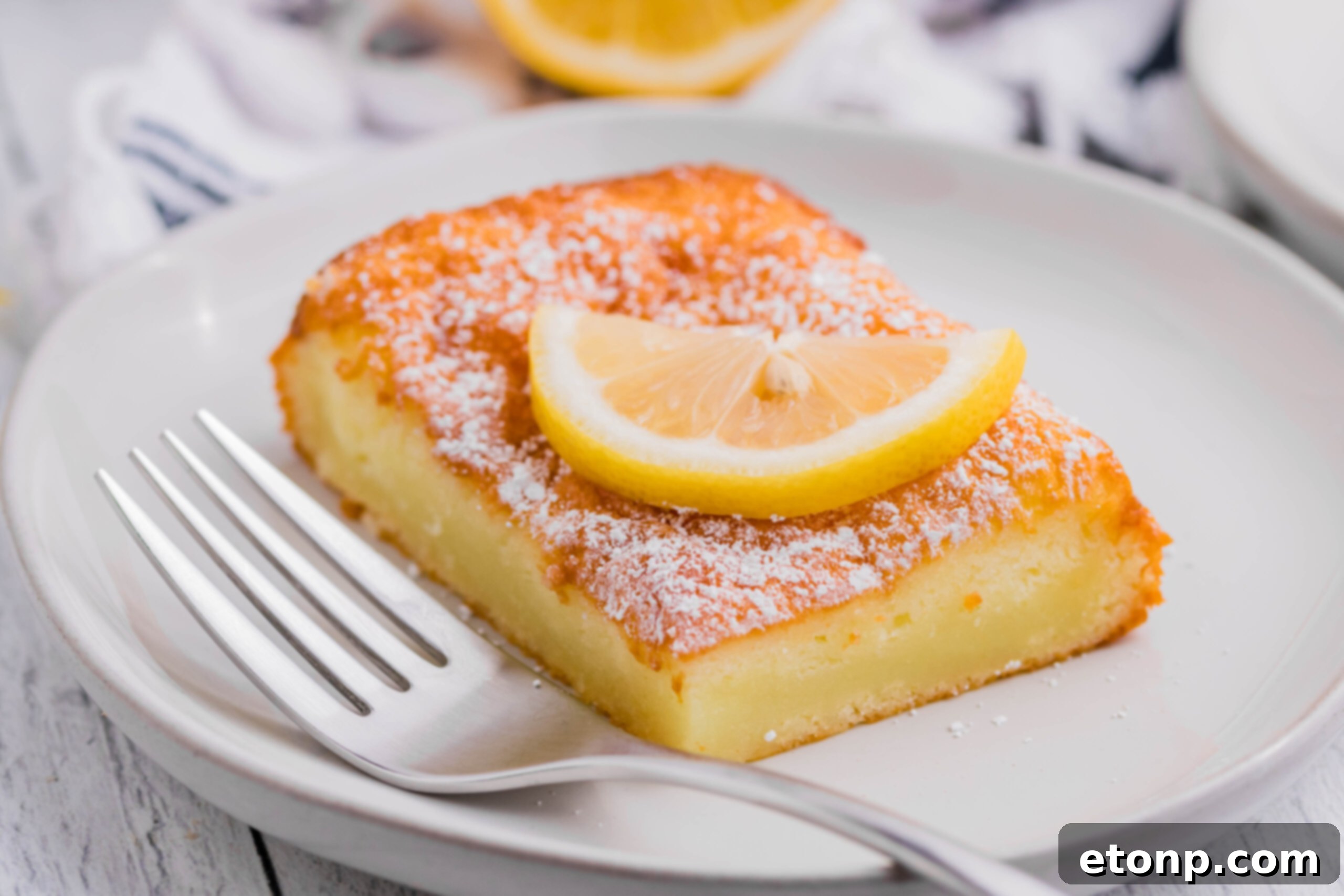 Close-up view of 2-Ingredient Lemon Bars, highlighting the delicate texture and golden-brown top