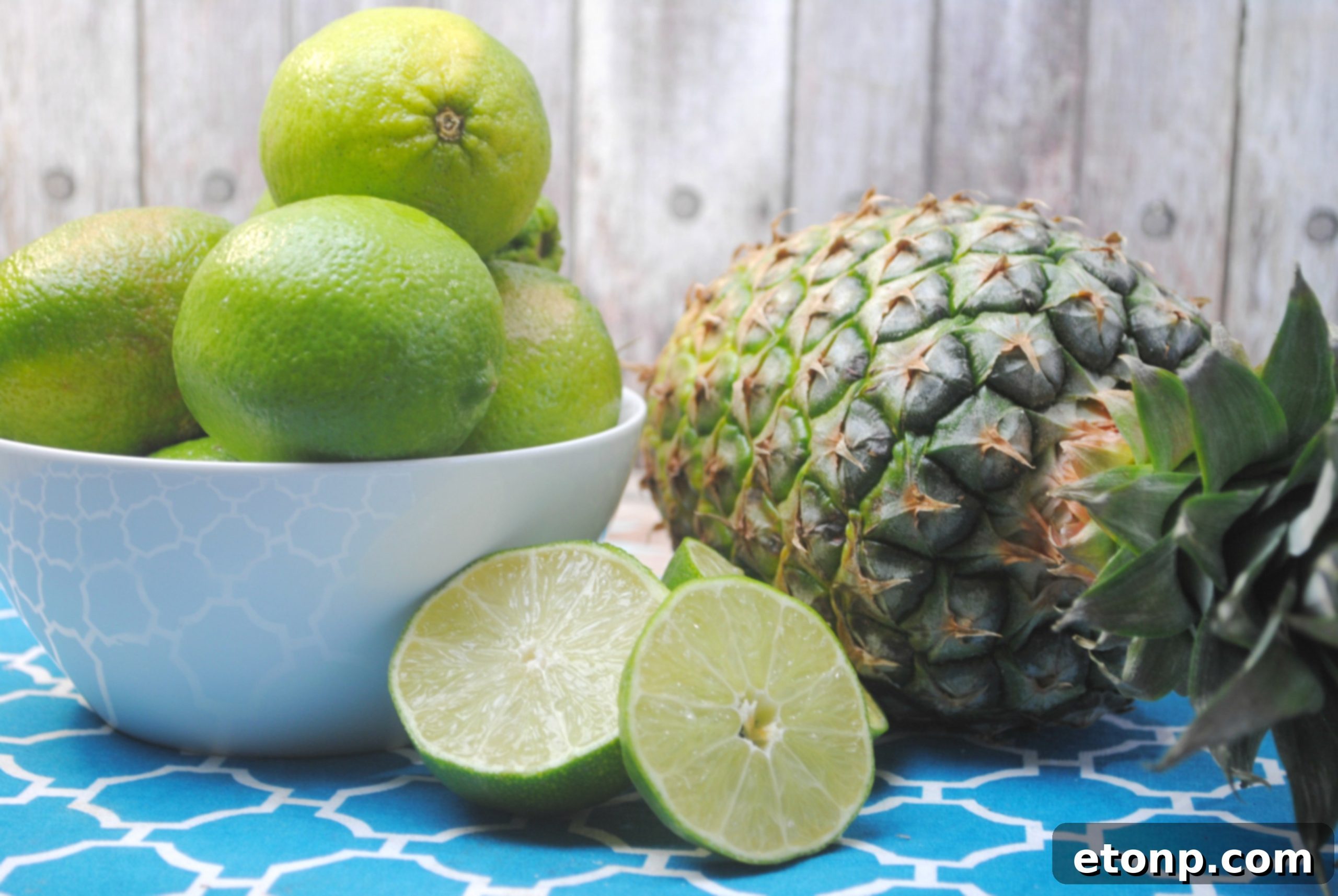 Two beautifully presented Kinky Pineapple Margaritas, with blue sugar rims, ready to be enjoyed.