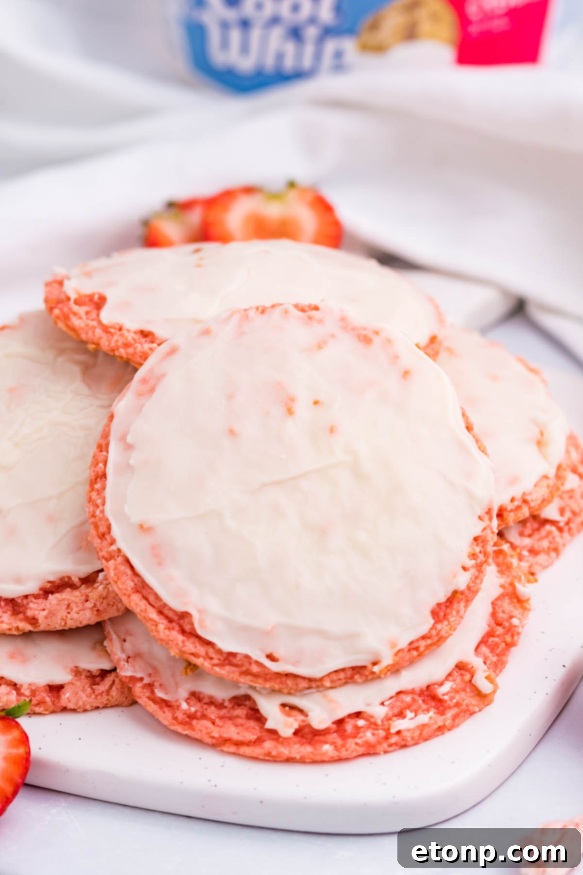 Strawberry Cool Whip Cookies piled neatly on a white plate, ready to be enjoyed