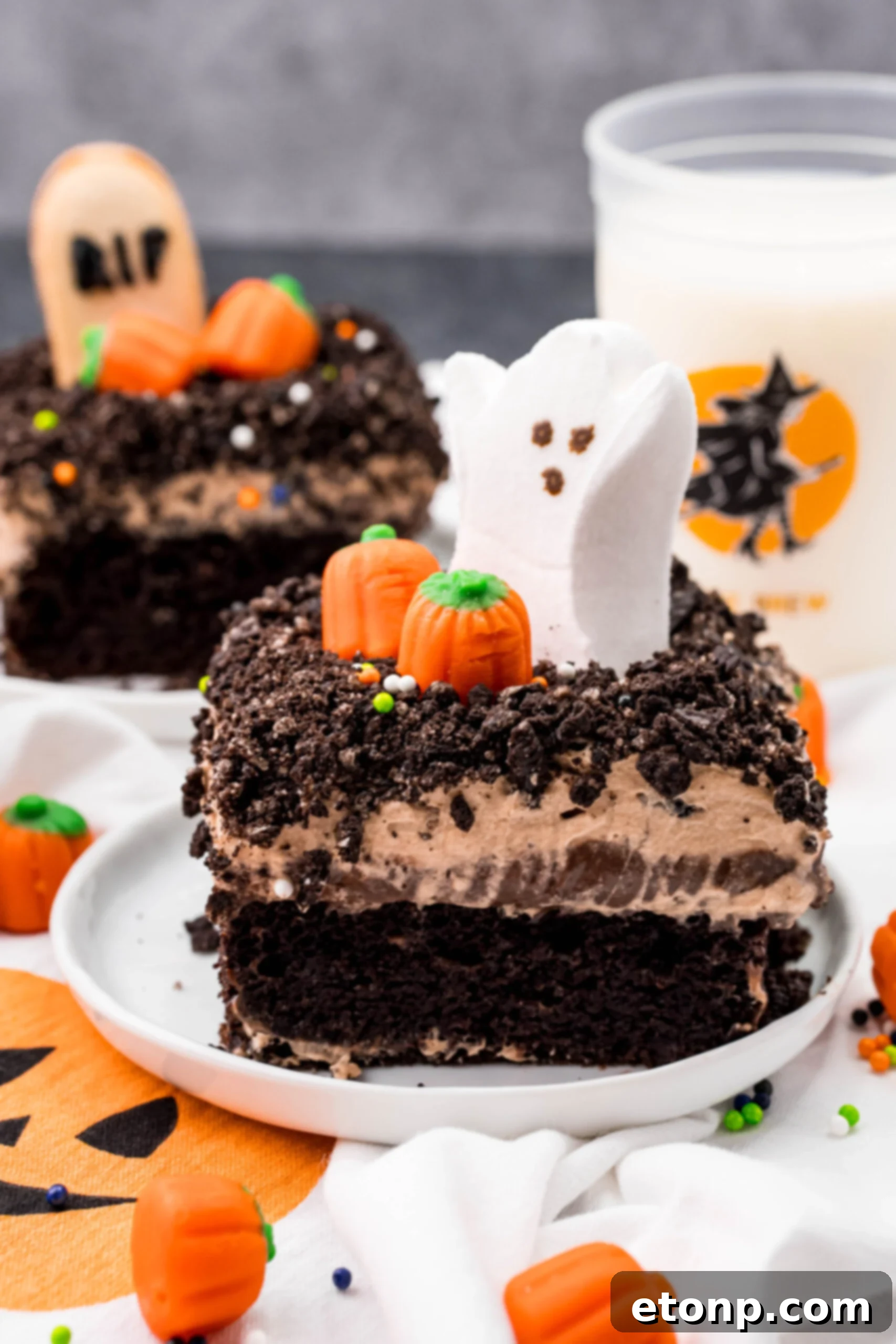 A fresh slice of Halloween Dirt Cake presented on a white plate, highlighting its distinct layers and appealing texture.