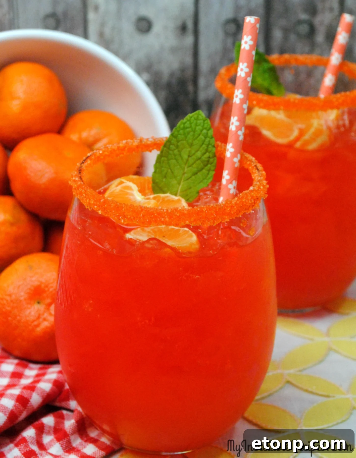 Fresh Halo oranges arranged on a rustic wooden board, ready for juicing, next to a glass.