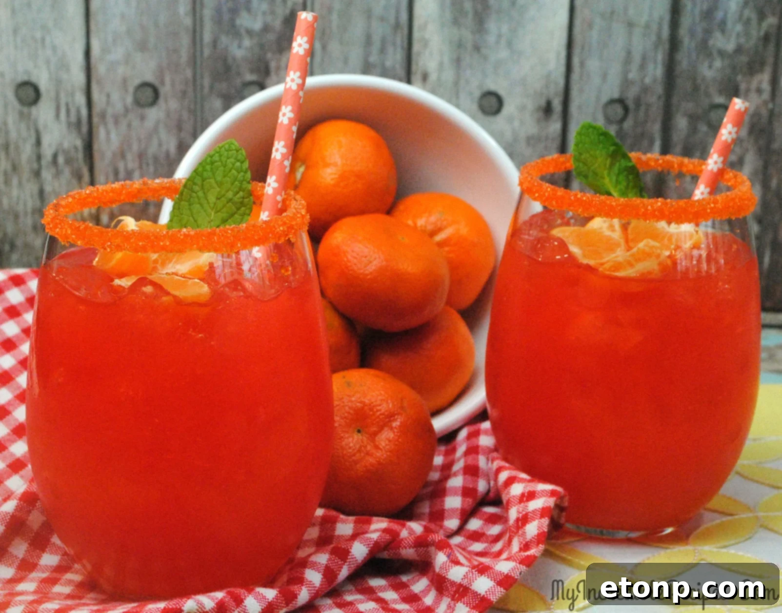 A vibrant Halo Orange Margarita served by a swimming pool, ready to be enjoyed on a hot day.