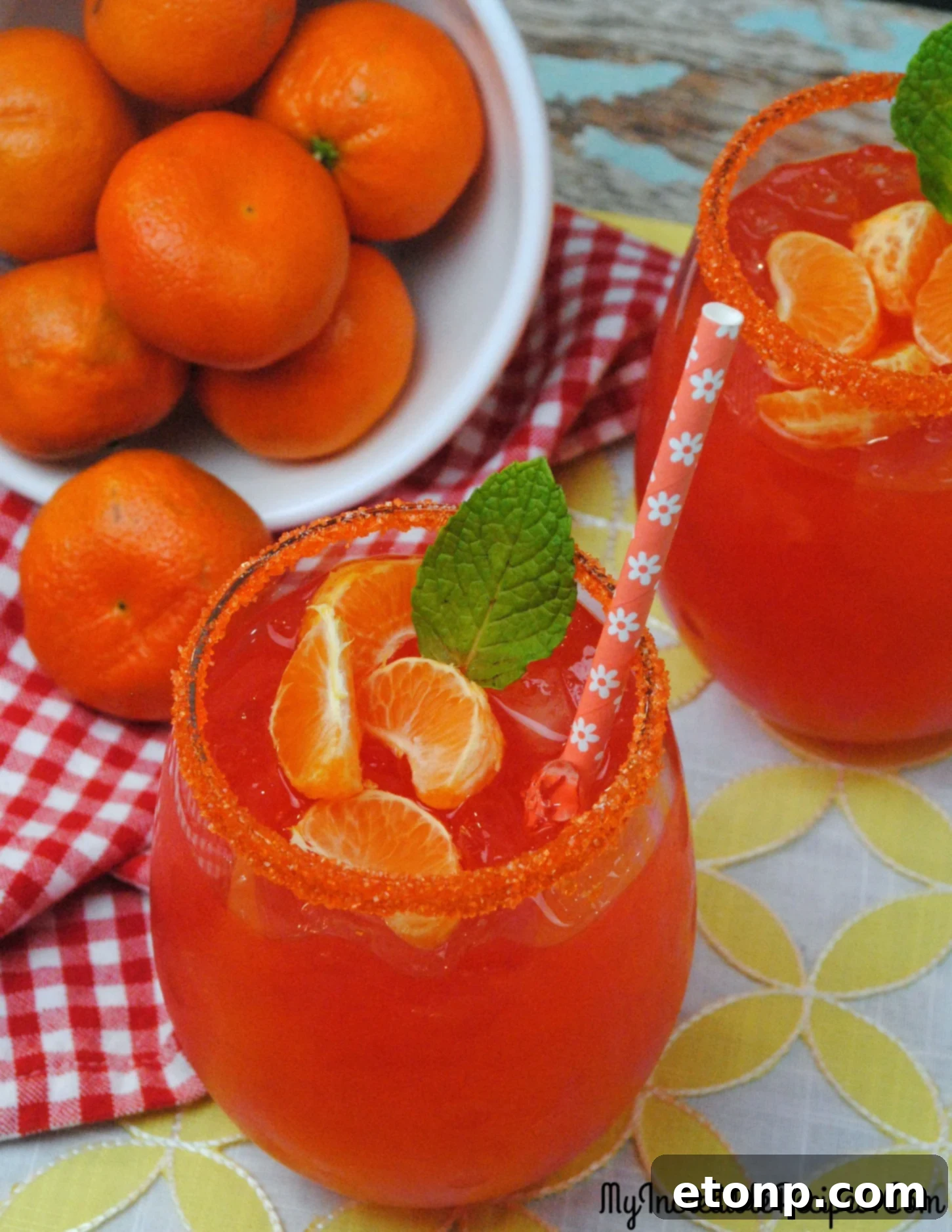 An artfully presented Halo Orange Margarita with a sugar rim and mint garnish.