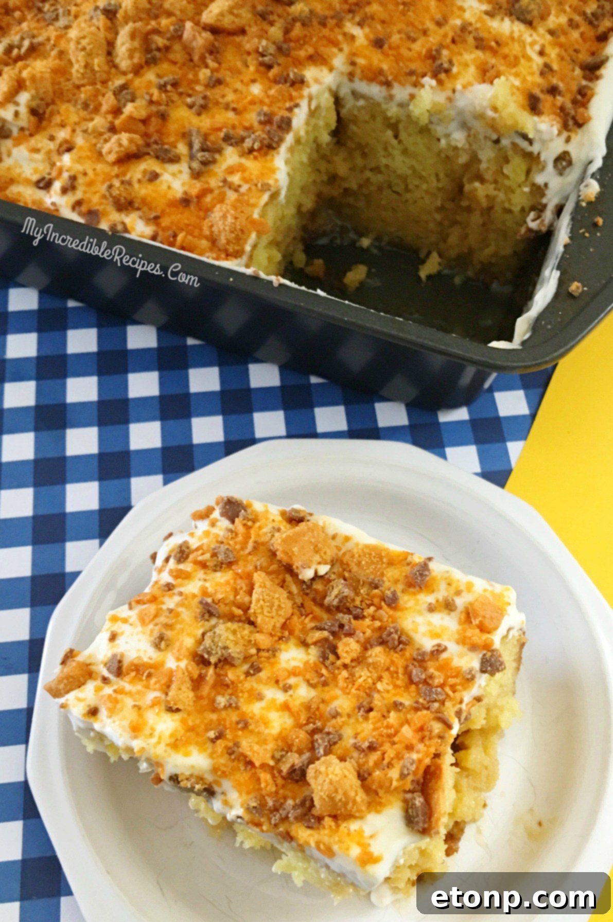 Butterfinger Bliss Cake 10 a slice of Butterfinger Caramel Poke Cake on a plate