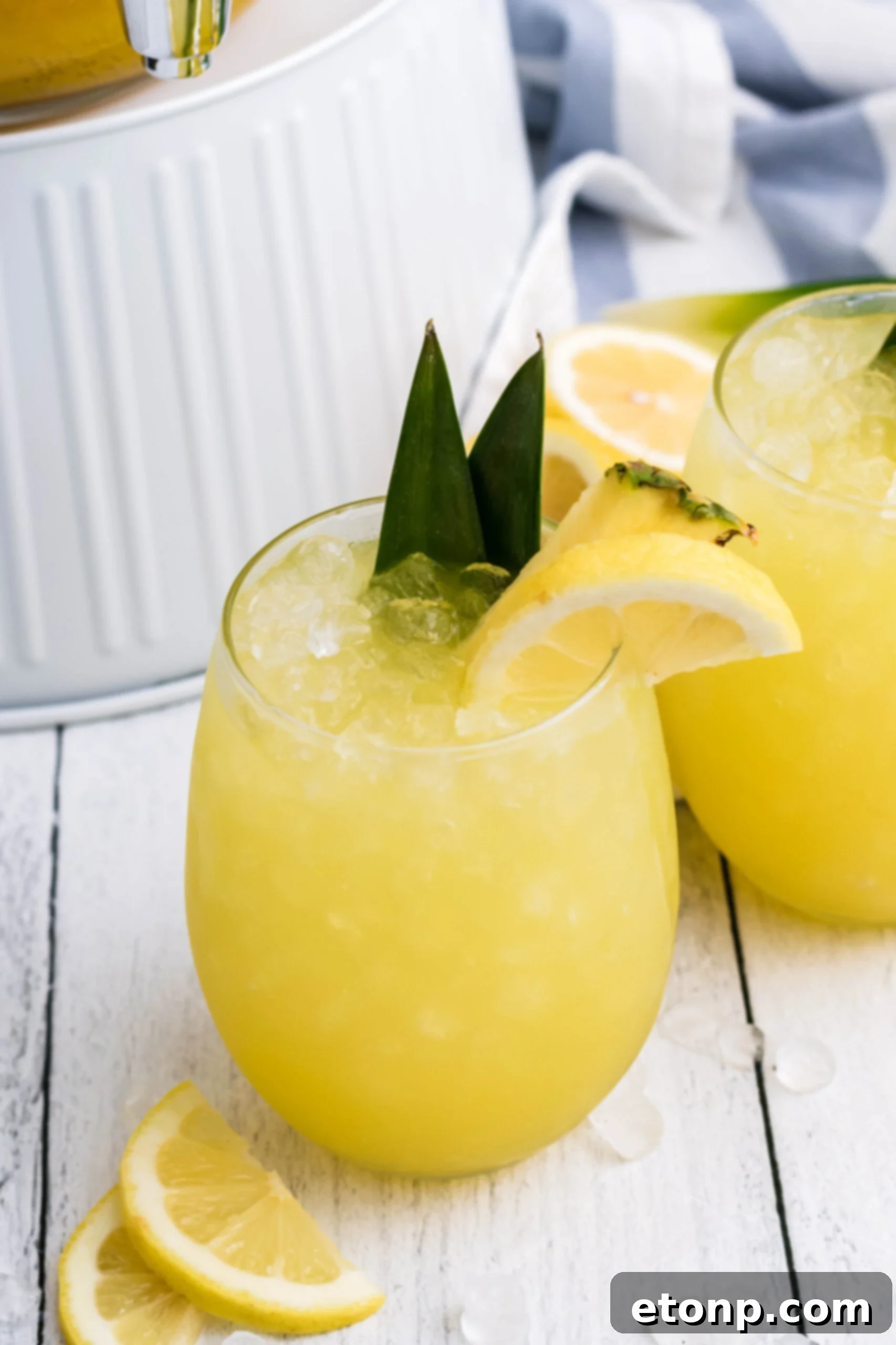 Overhead shot of Pineapple Lemonade in a clear glass with ice, showing the vibrant yellow hue