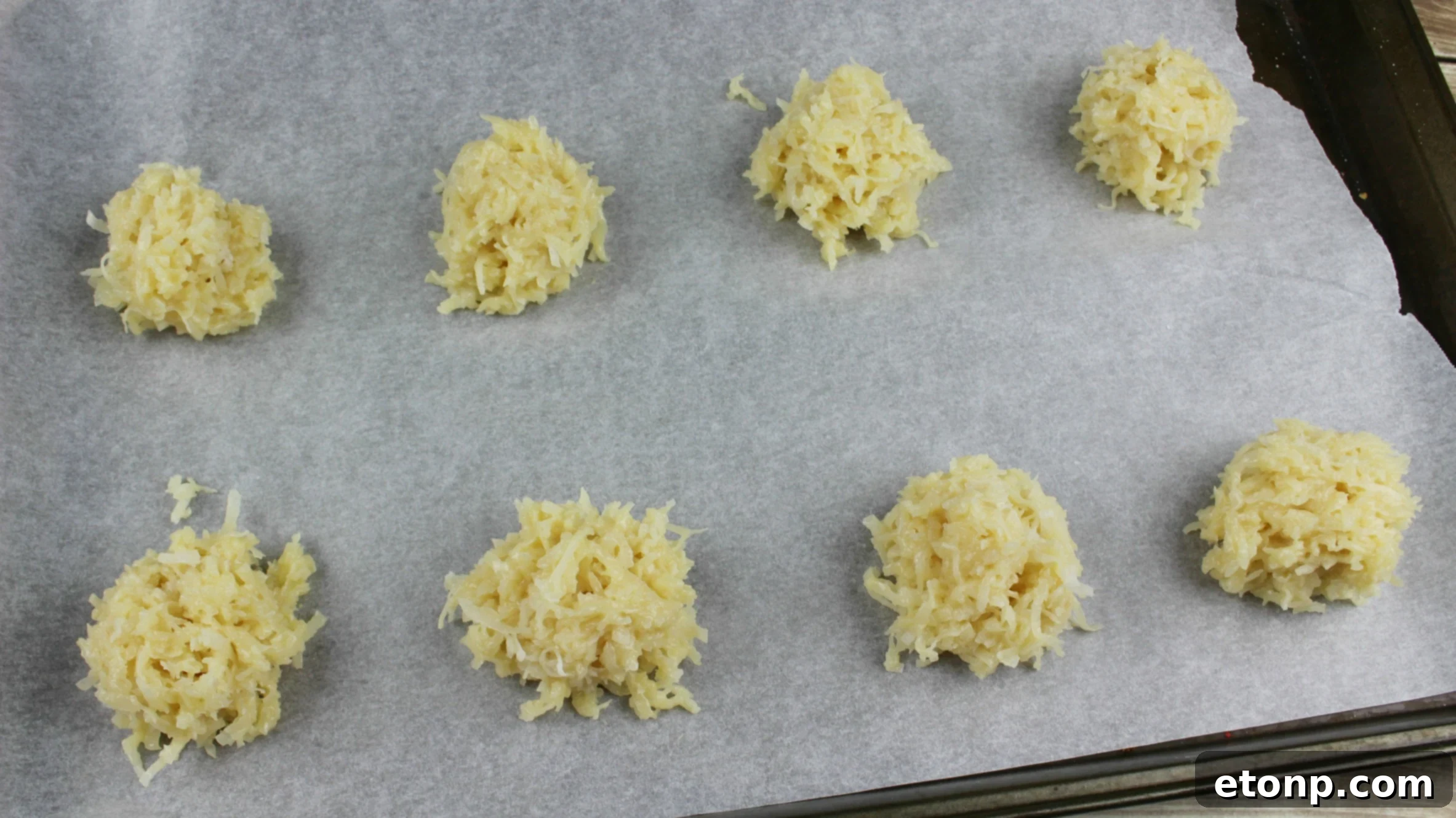 Platter of blue and white chocolate-dipped coconut macaroons with red cherries, ready for a 4th of July celebration