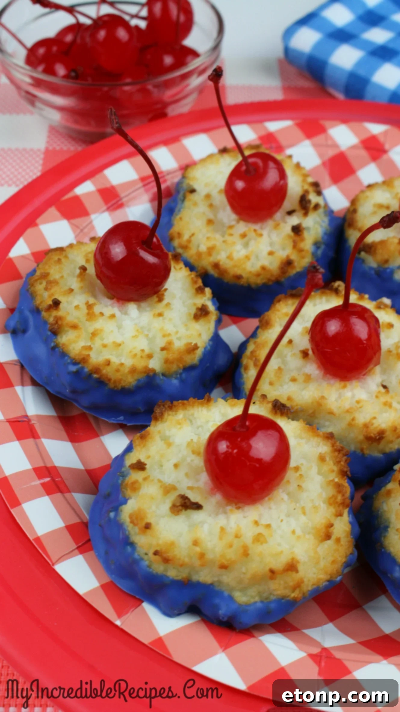 Several finished coconut macaroon cherry bombs arranged beautifully on a plate, ready for a party