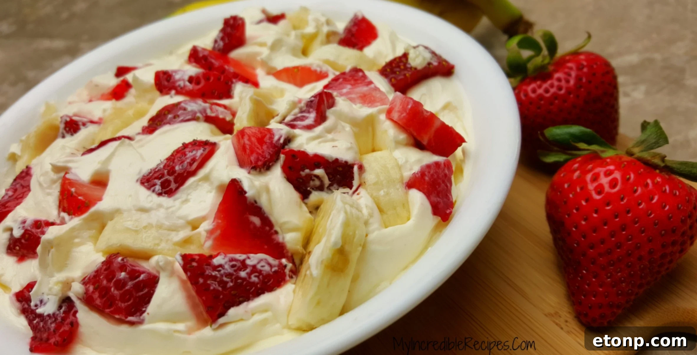Strawberry Banana Cheesecake Salad Bliss 7 A person enjoying a spoonful of Strawberry Banana Cheesecake Salad, showing visible delight.