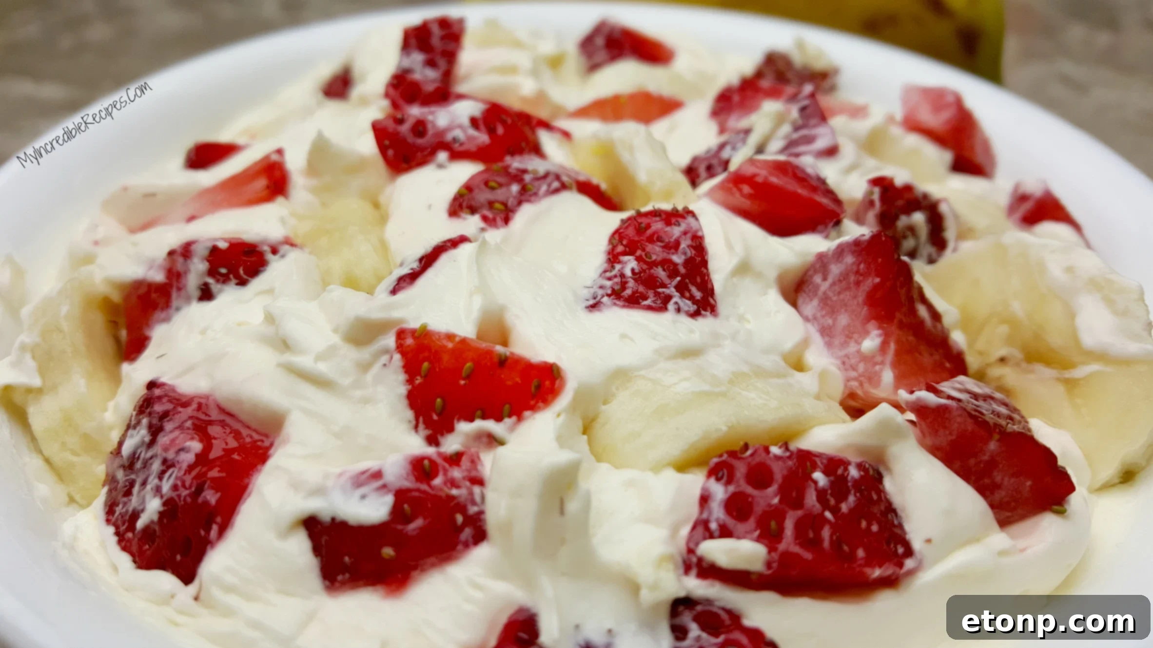 Strawberry Banana Cheesecake Salad Bliss 10 A close-up of the Strawberry Banana Cheesecake Salad, highlighting the fresh and juicy fruit.
