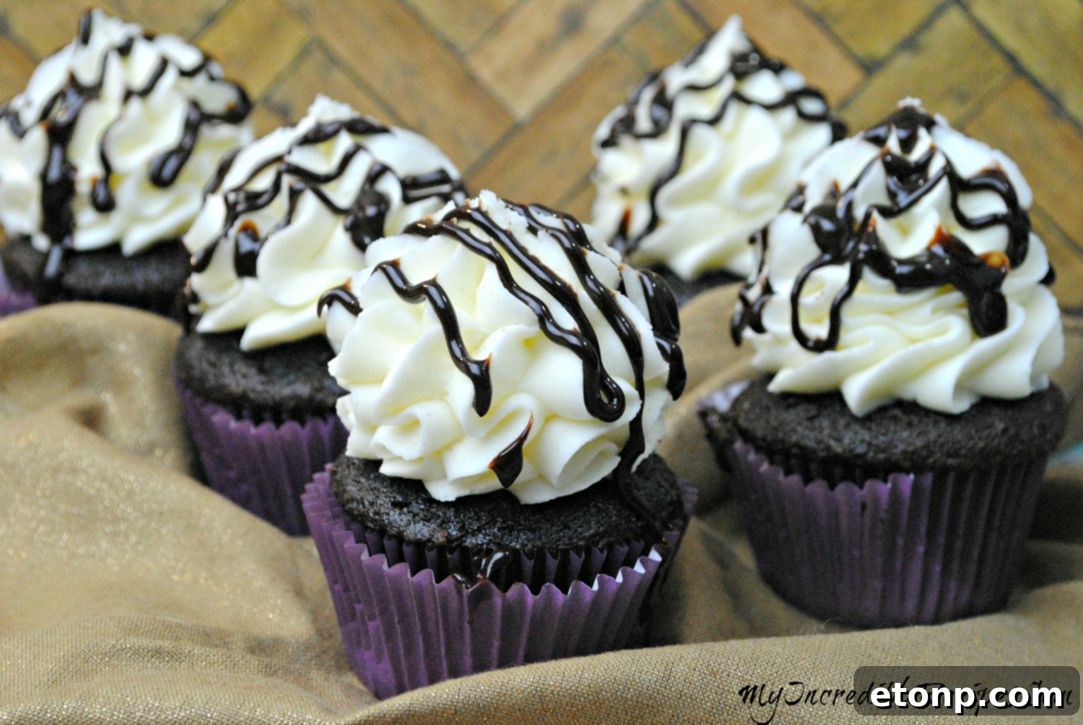 Decadent Kahlua Chocolate Cupcakes 3 Close-up of a chocolate Kahlúa cupcake with a visible luscious filling inside.
