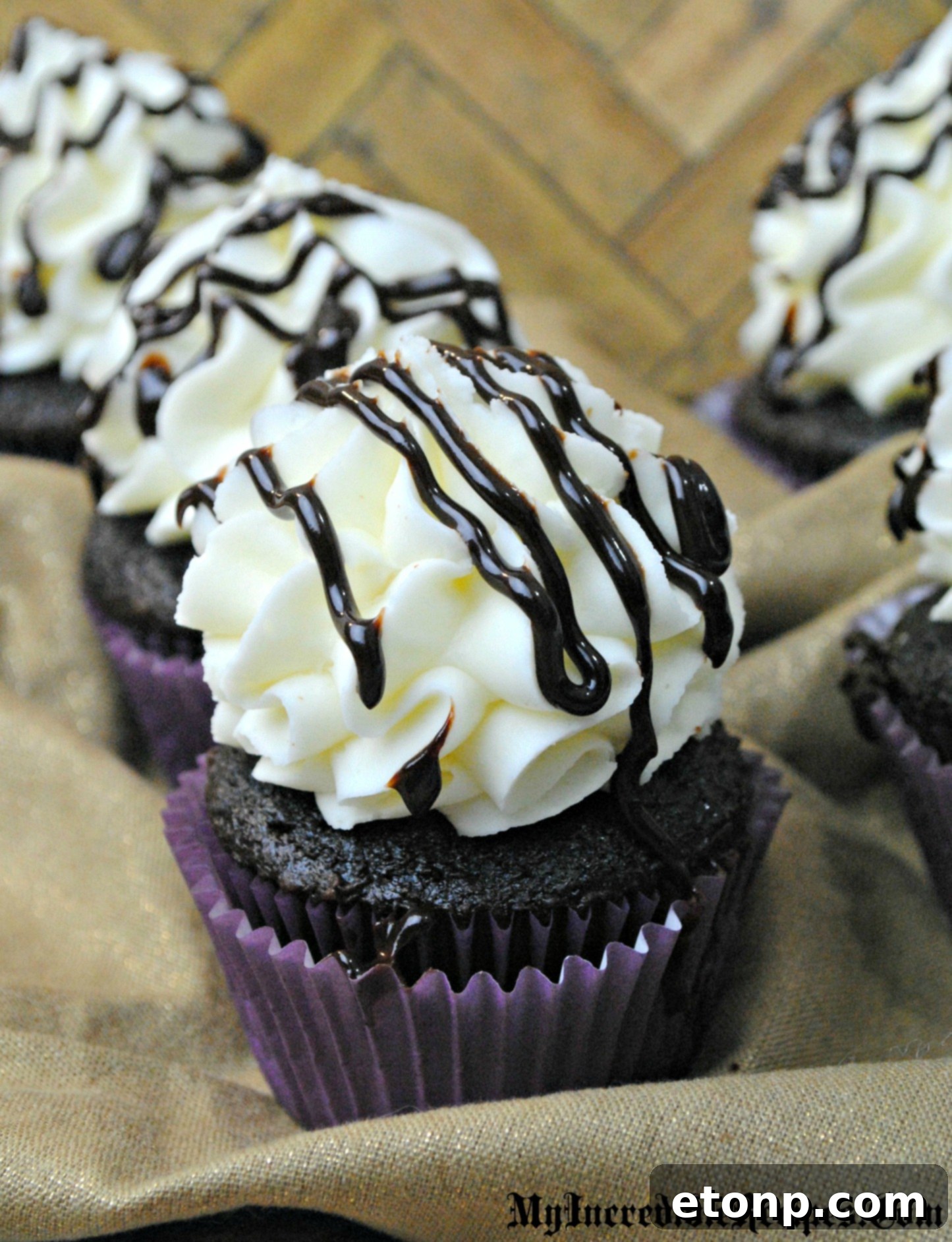 Decadent Kahlua Chocolate Cupcakes 4 A Kahlúa chocolate cupcake cut in half to showcase the decadent liquid chocolate filling oozing from the center.