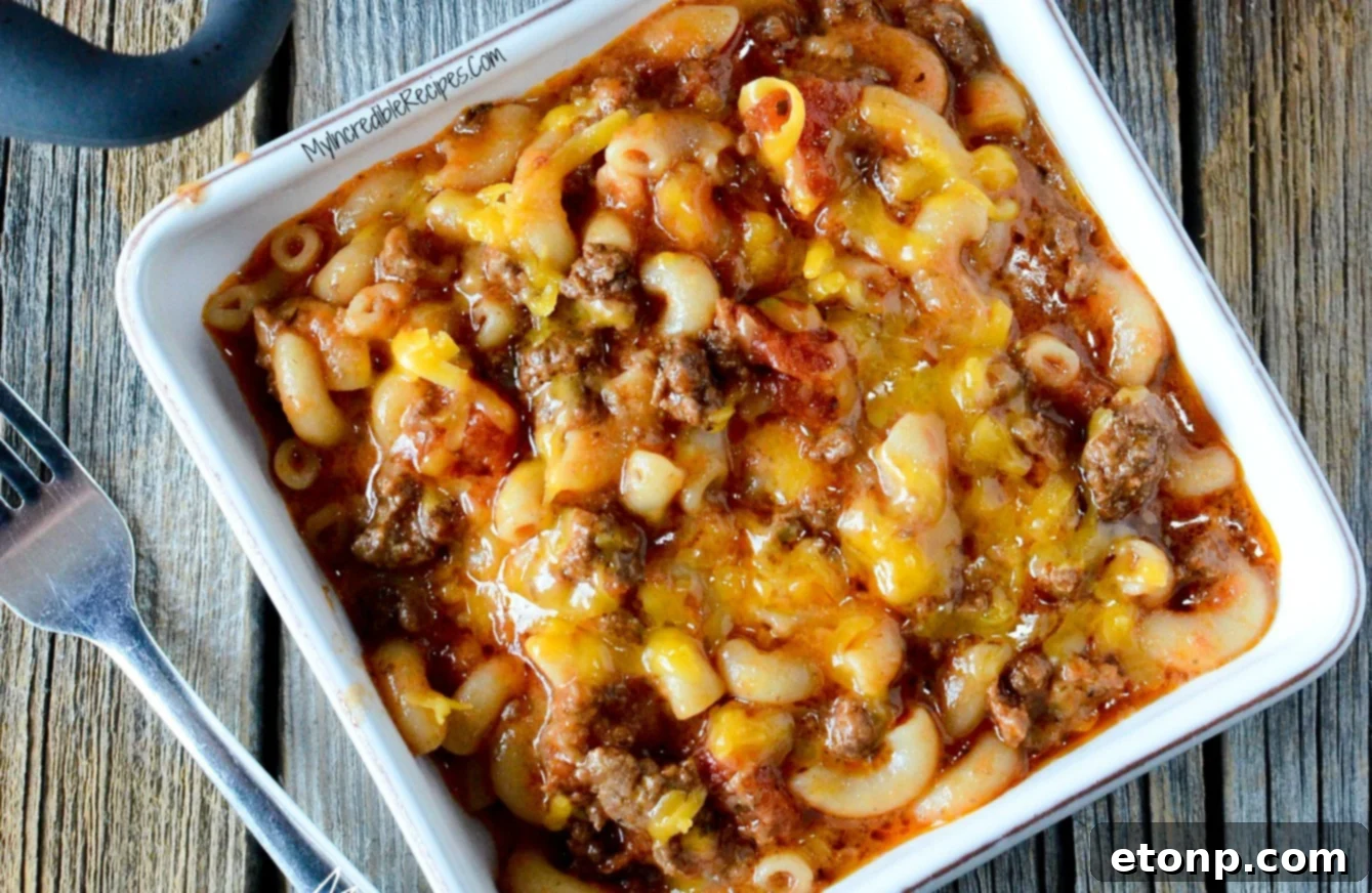 Homestyle Goulash 15 Old Fashioned Goulash in a white square bowl on a wood table