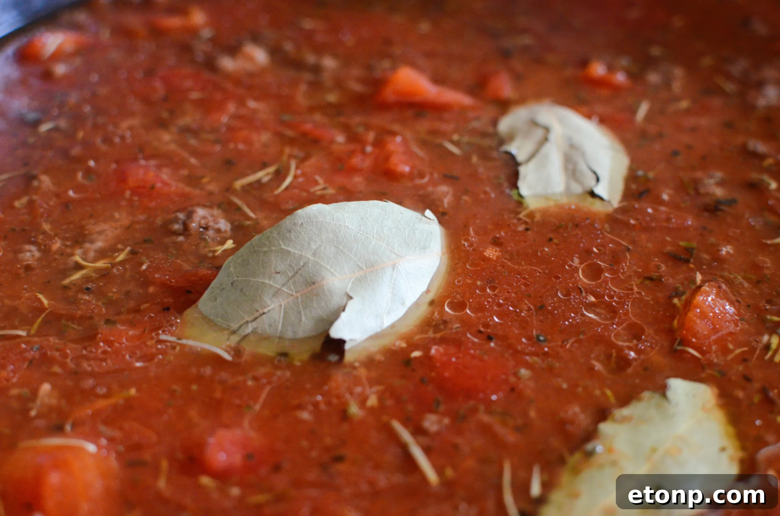Homestyle Goulash 4 Old Fashioned Goulash simmering in a pot topped with bay leaves