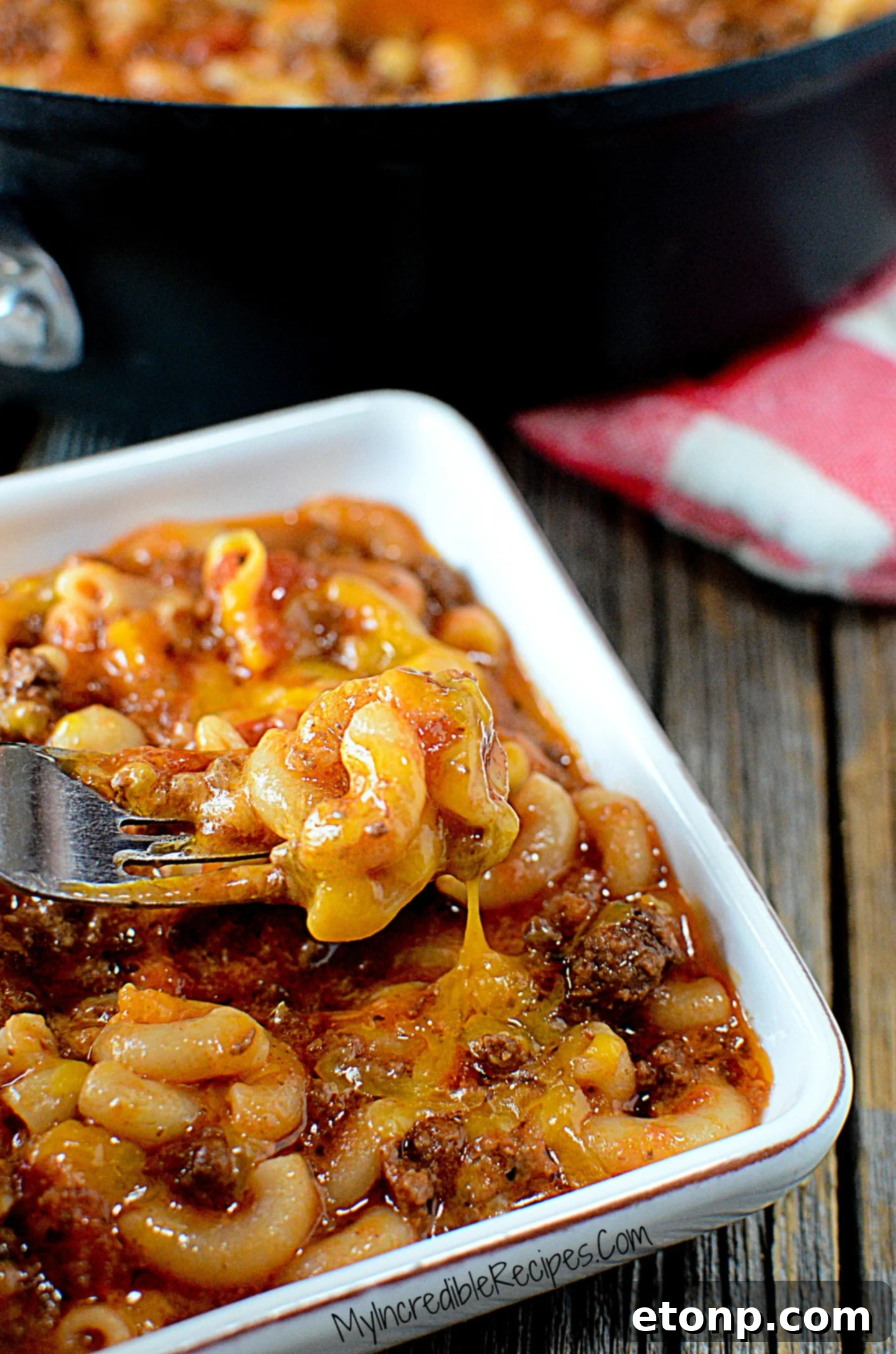 Homestyle Goulash 9 Old Fashioned Goulash in a white bowl with a fork grabbing a bite