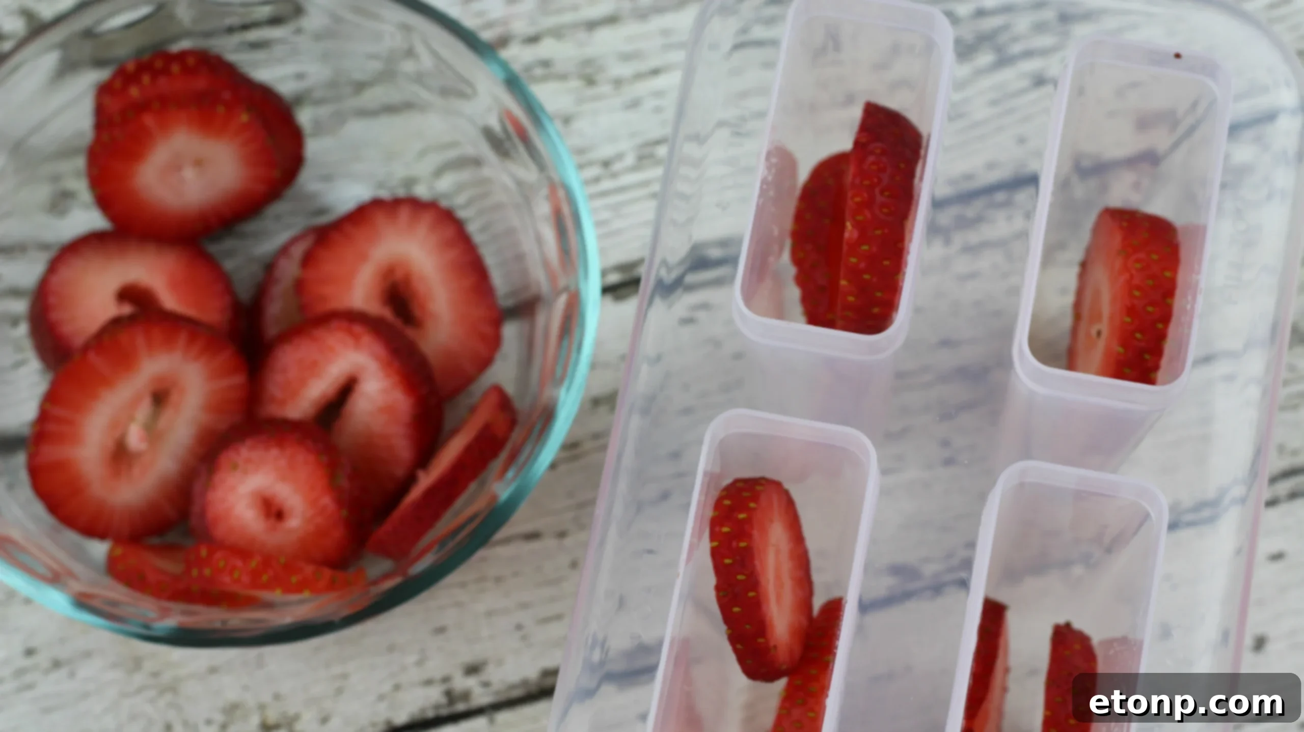 Frozen Strawberry Cantaloupe Sangria Popsicles, elegantly presented with a wine bottle
