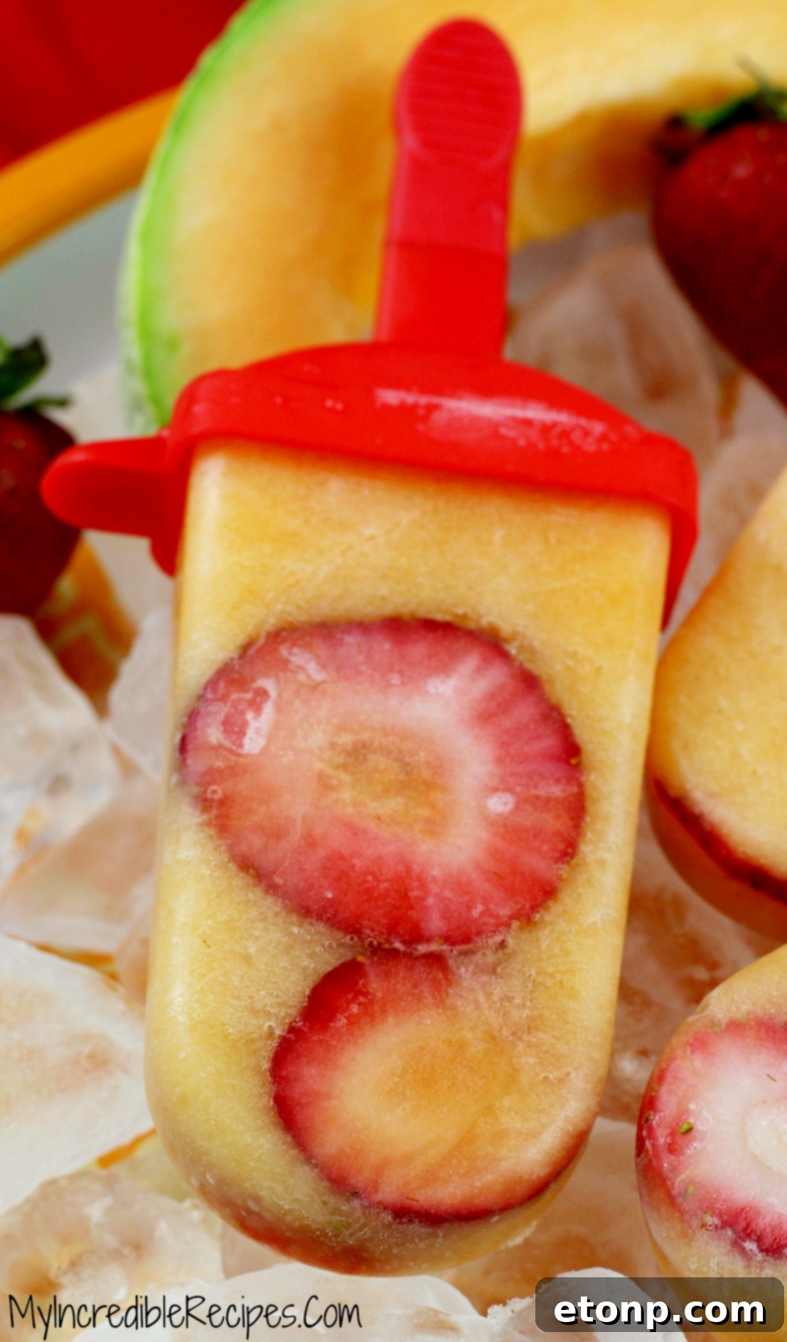 Three homemade fruit popsicles with distinct vibrant colors, beautifully arranged