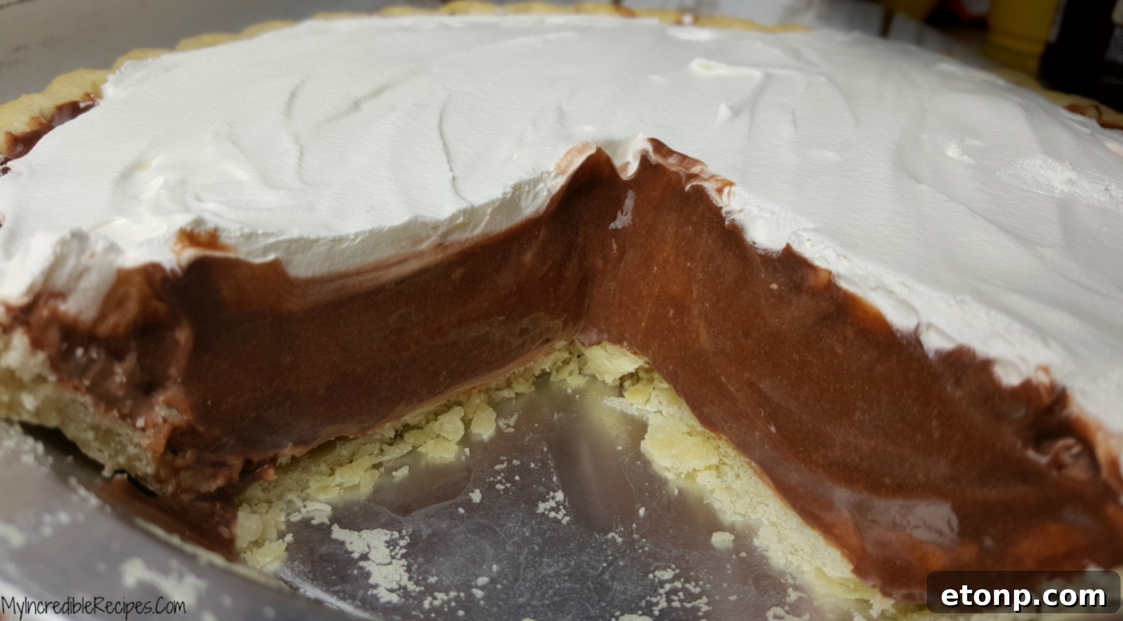 A whole chocolate cream pie on a decorative dish