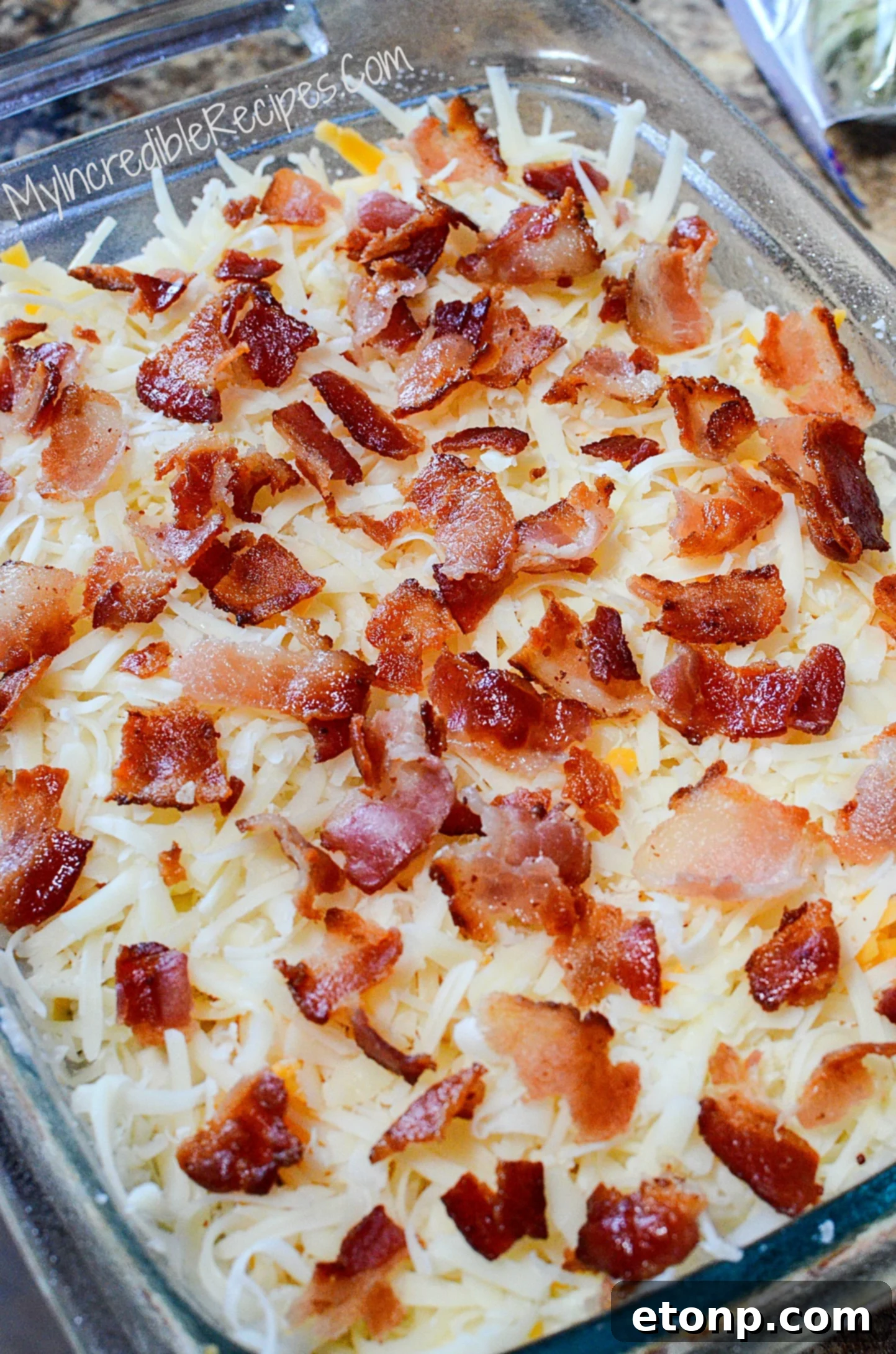 Ultimate Chicken Bacon Ranch Bake 5 Chicken Bacon Ranch Casserole topped with cheese and bacon, ready for oven