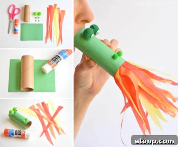 Colorful paper roll dragon craft with accordion paper body and googly eyes, standing on a white surface.