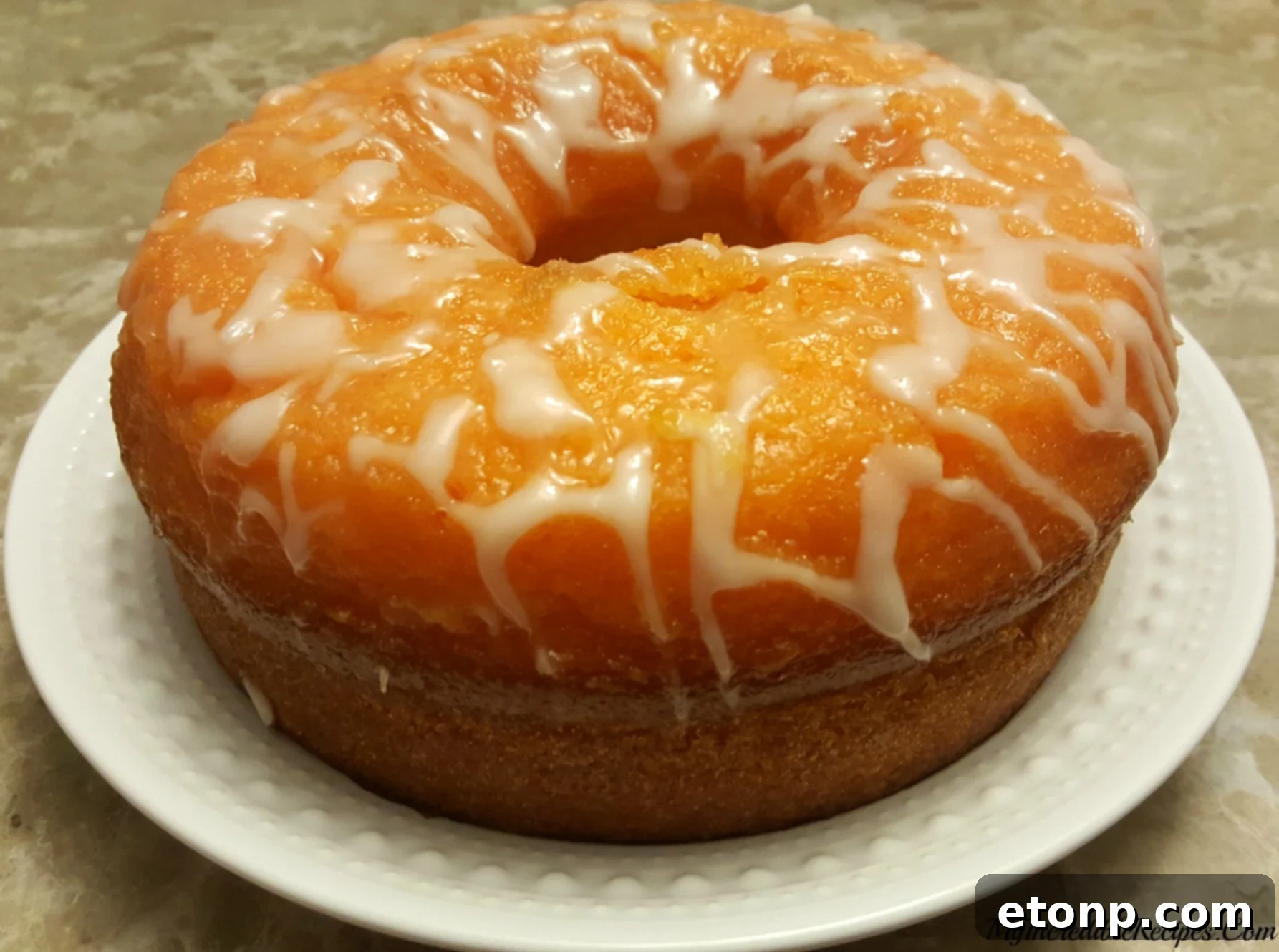 Orange Creamsicle Cake baking in a bundt pan